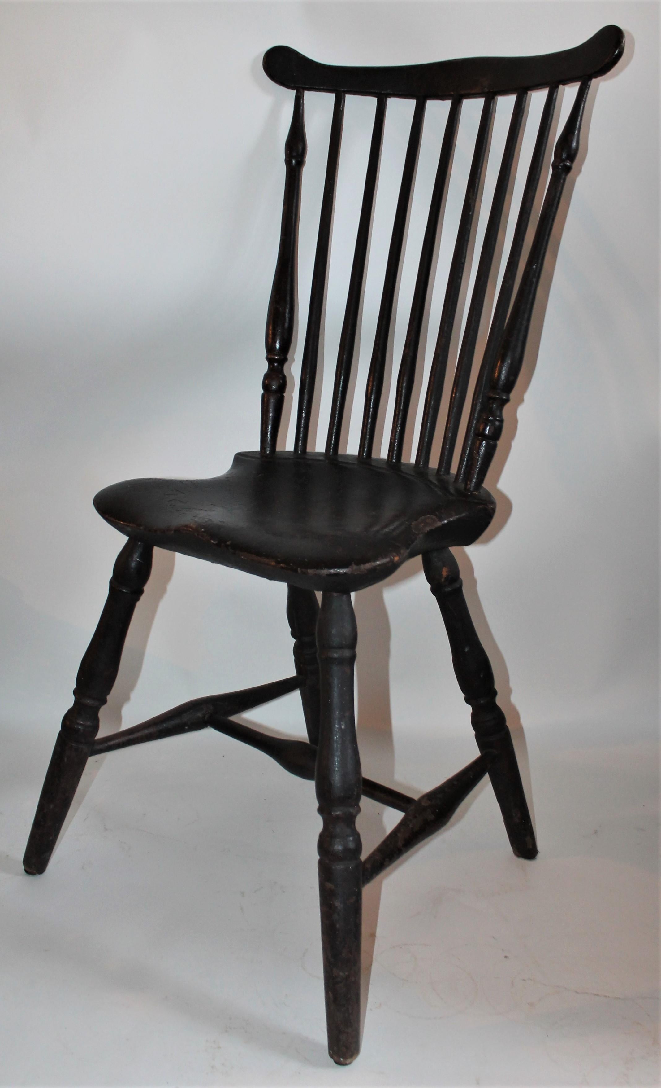 This fine 18th century saddle seat Windsor chair from New England has amazing untouched surface. The condition is very good and the chair is very sturdy. The black painted surface is untouched and a fine old patina. The chair is unsigned.