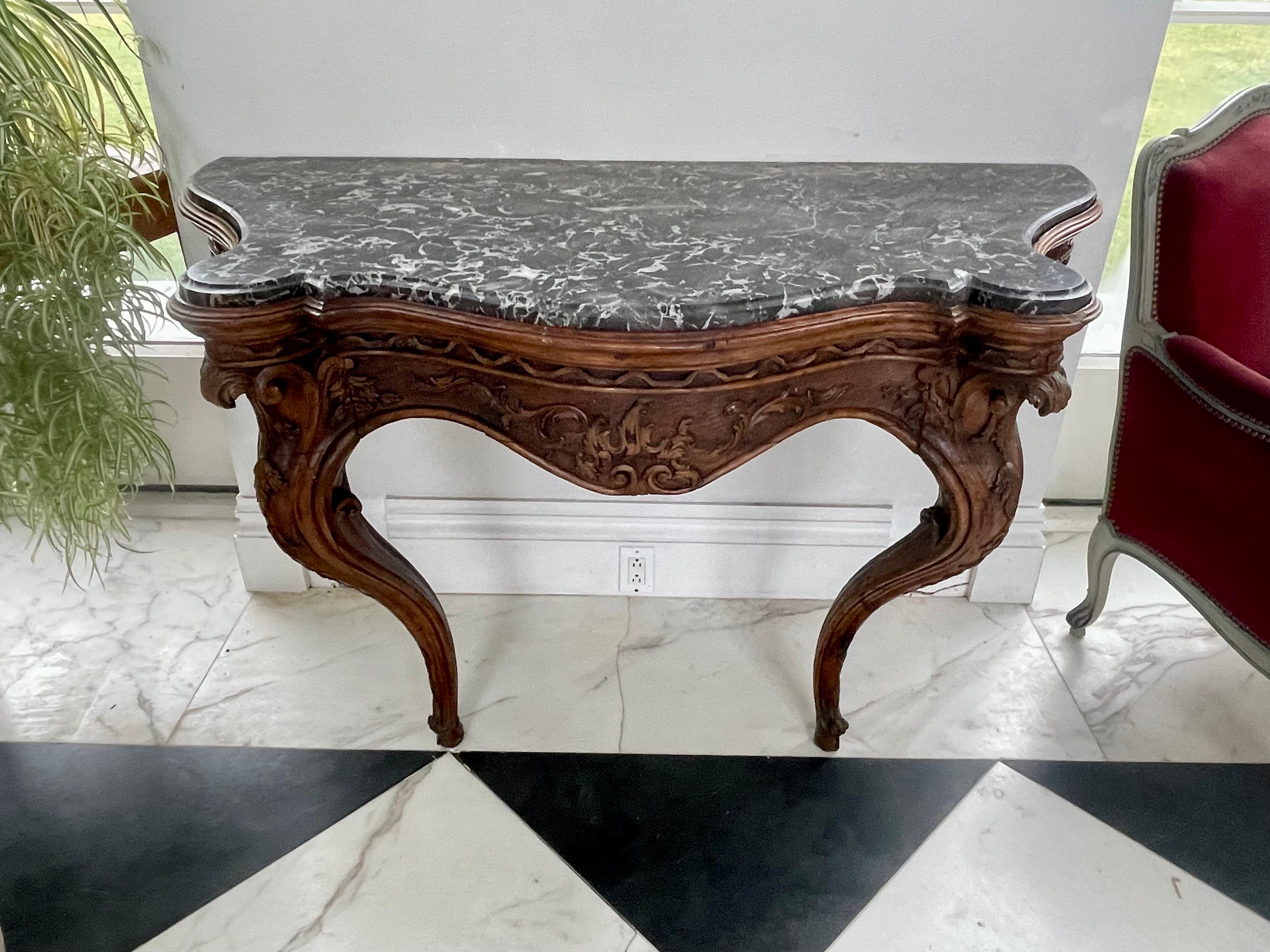 A large scale Louis XV period French walnut wall console table with original grey marble top, 1760.