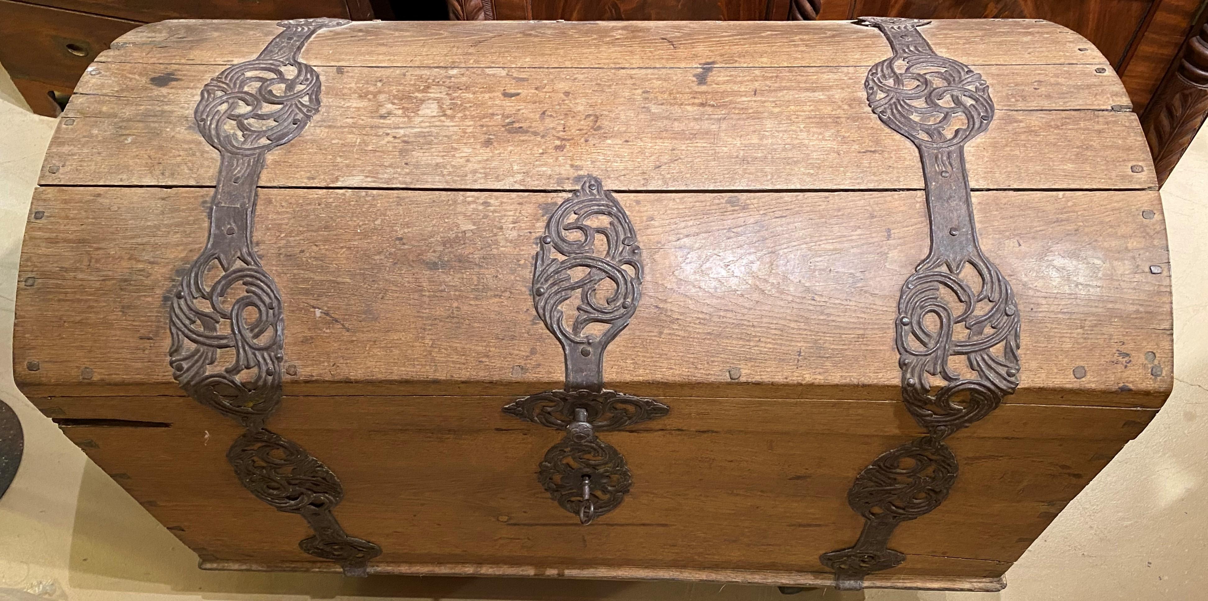 A fine oak dome top trunk with fabulous strap metalwork and hardware, dovetailed construction, and great patina. Continental in origin, dating to the 18th century, in very good overall condition, with some later hinge repair on one side, minor