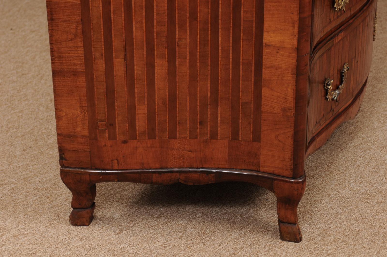  18th century continental parquetry inlaid commode with serpentine front, hoof feet, and 3 drawers.