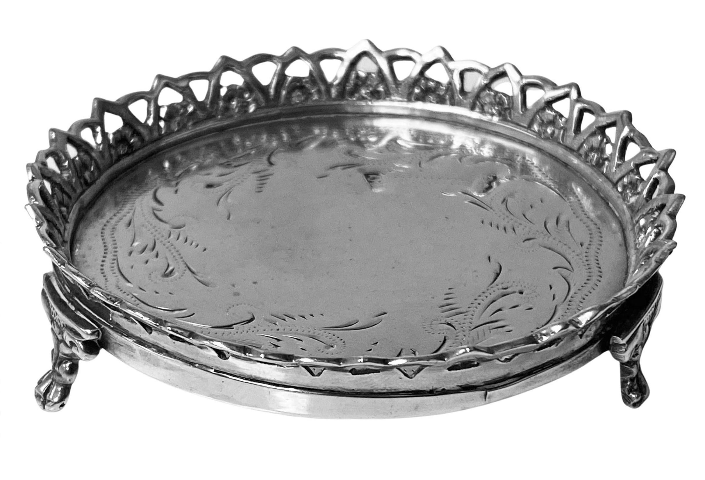 18th century Continental Silver Coaster Évora Portugal  C.1780. The round coaster on three foliate paw supports, the centre with engraved pin pricked and foliate decoration upper applied pierced and foliate border. Continental marks to coaster.