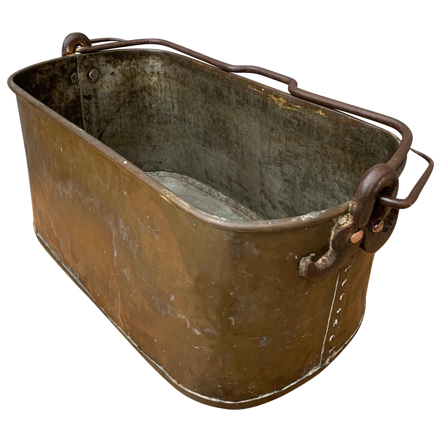 An 18th century copper and forged iron big bucket. All hand hammered with handmade copper rivets and hand forged iron handle. Most probably used for bringing and keeping wood by the chimney.
