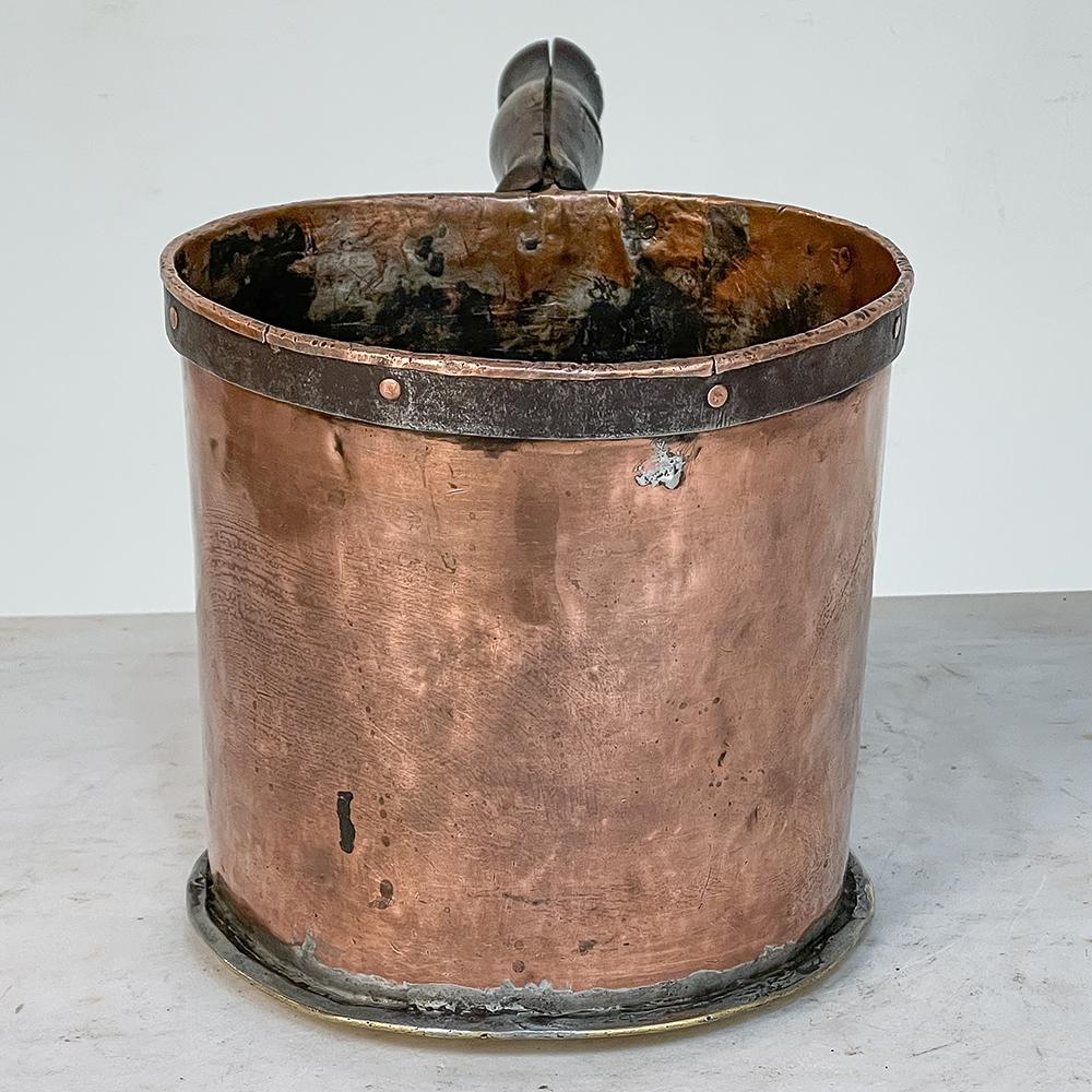 18th century Copper & Brass Saucepot with Handle is a marvelous relic from a bygone era! Meant for an affluent family's kitchen, it was designed to produce a goodly amount of sauce, perhaps even chocolate in nature, for embellishing a fine meal. The