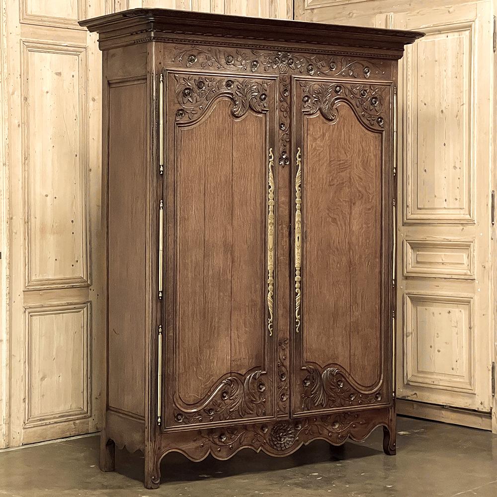18th Century country French Armoire from Normandie is a stunning study in whimsical naturalism, executed in old-growth indigenous oak by the master artisans of the storied region! A multi-tiered, broad crown presides over the casework, with finely
