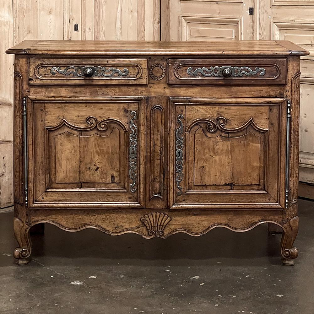 18th century Country French Cherry Wood Buffet reveals the splendor of the French style exhibited by talented rural artisans following the influences set forth by the court. The Louis XIV style is evident in this expression, with a bold yet stylized