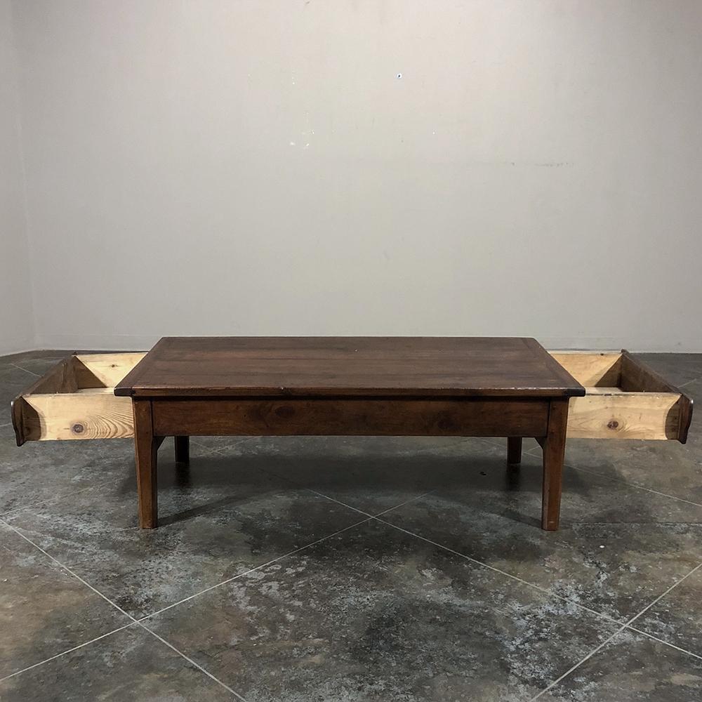 18th century country French coffee table was fashioned by talented rural artisans from local fruitwood, and features handcrafted pegged mortise and tenon joinery and two enormous drawers on each end for superb functionality,
circa 1770s
Measures: