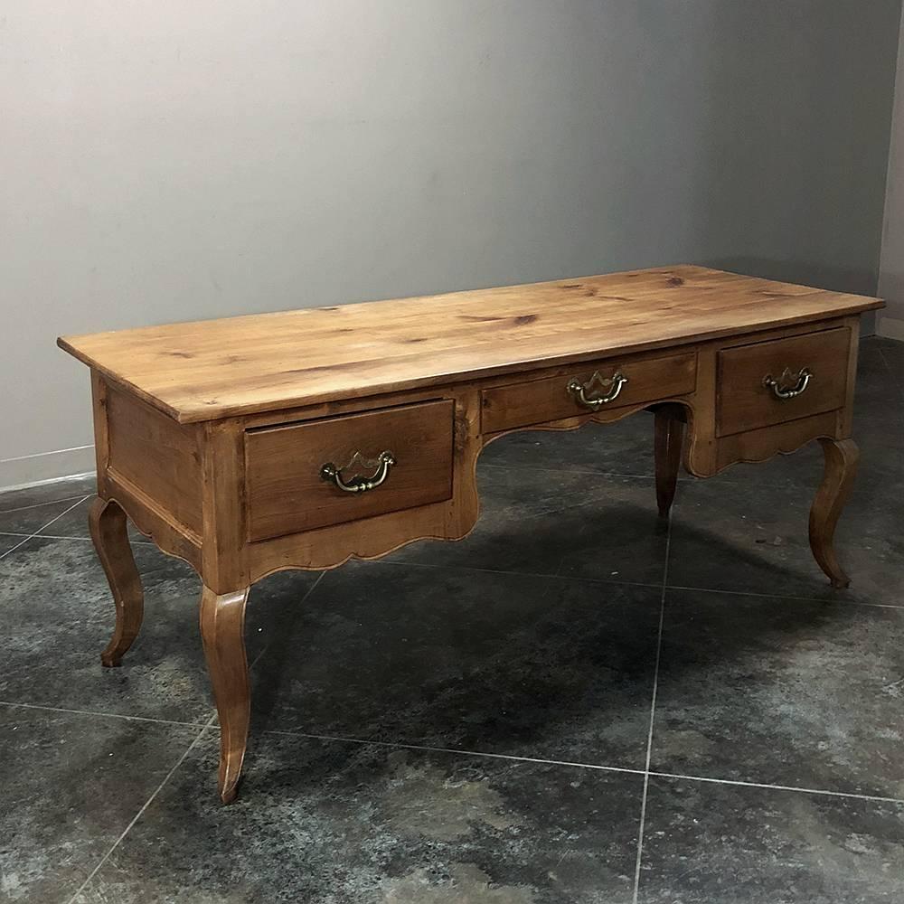 18th century Country French fruitwood desk was fashioned by talented rural artisans from local fruitwood, and features a finish on all four sides, making it ideal for placement in the center of the room! Gracefully contoured apron, supported by