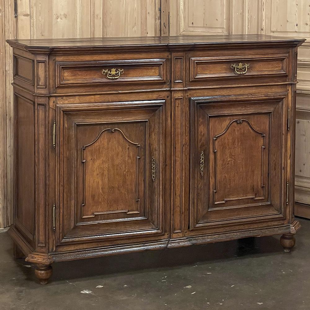 18th century Country French Louis XIII Buffet provides the epitome of understated elegance while serving as a capacious storage piece for all your cherished family heirlooms! Hand-crafted by master artisans using what are today considered primitive