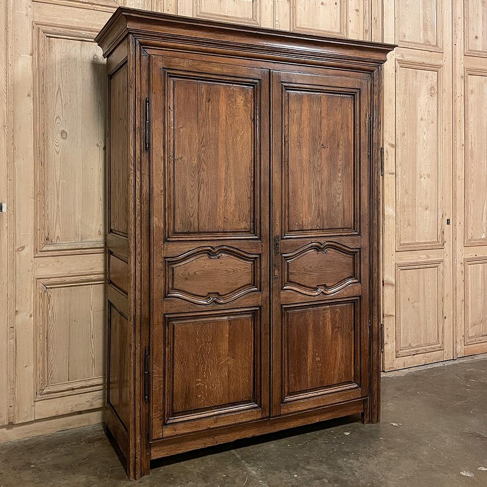 18th Century Country French Louis XIV Armoire was meticulously hand-crafted on a relatively diminutive scale from dense, old-growth indigenous oak to literally last for centuries! Although more difficult to work than other woods, oak was chosen for