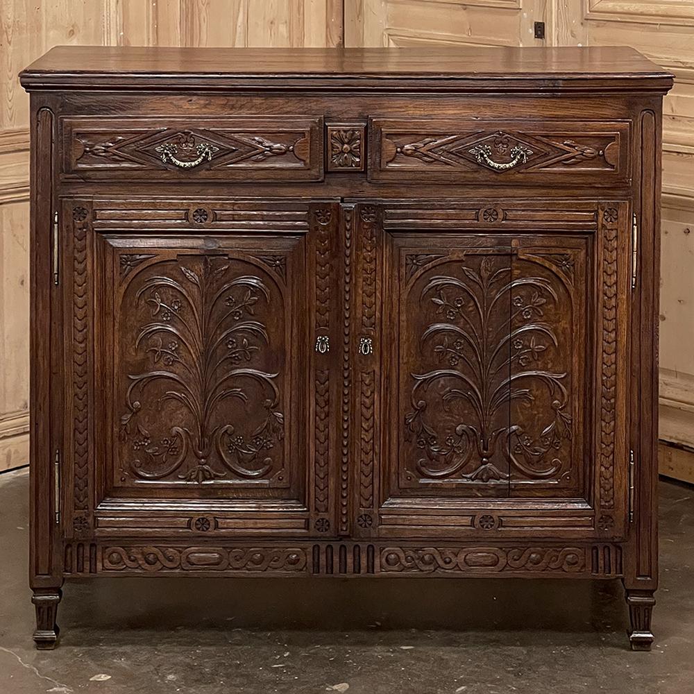 18th Century Country French Louis XVI Buffet is a period piece that exemplifies the artistry and traditional craftsmanship of the rural cabinetmaker during the period. Utilizing dense, old-growth oak, the casework was fashioned with neoclassical