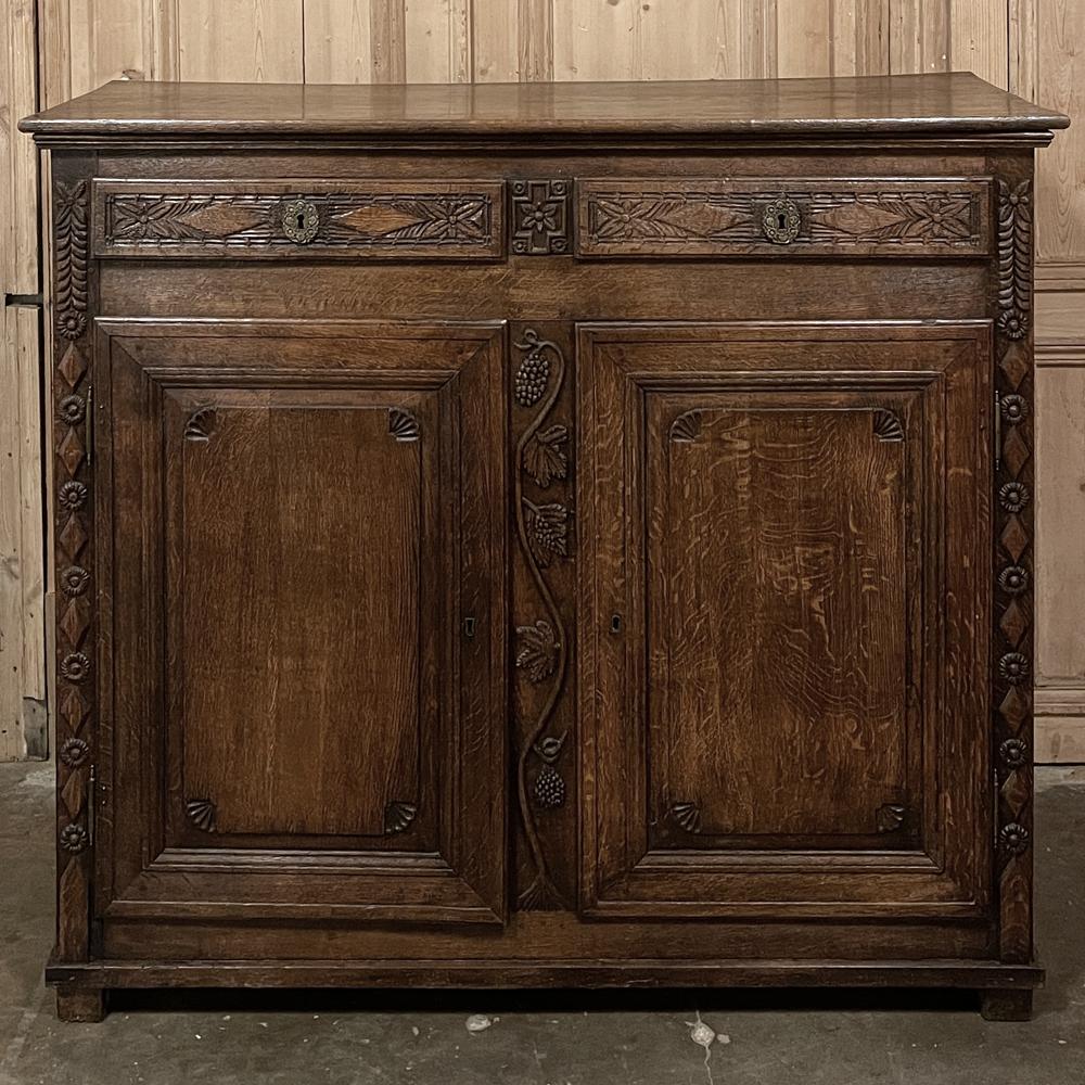 18th Century Country French Louis XVI Period Buffet is an intriguing blend of style elements that make it quite unique! Raised diamond forms appear on the drawers and corners, with stylized florals, rosettes, shells and even fully laden grapevines