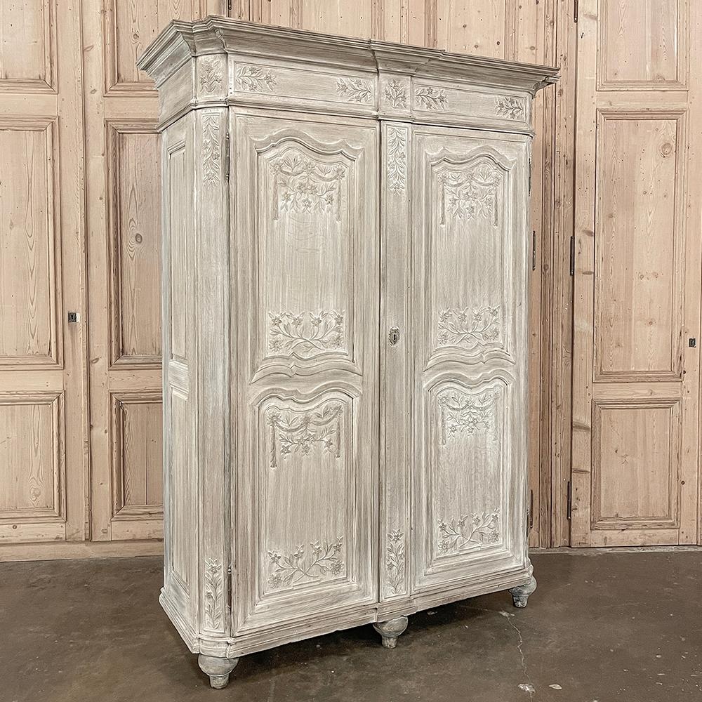 18th Century Country French Louis XVI Period Whitewashed Armoire will instantly become the focal point of any room!  Arresting visual presence begins with the impressive multi-tiered crown molding that follows the contours of the casework below