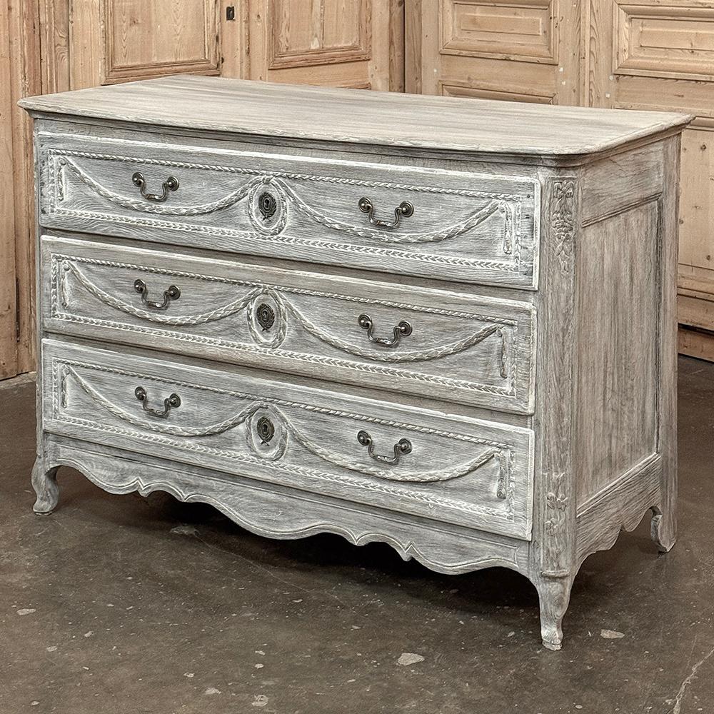 18th Century Country French Louis XVI Period Whitewashed Commode is a stately reminder of a timeless style that has produced centuries of enjoyment!  Hand-crafted from dense, old-growth oak then carved with graceful laurel garlands framed by wheat