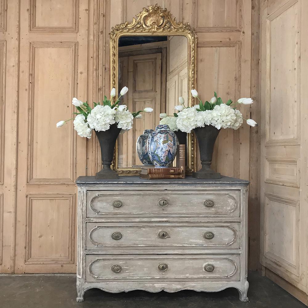 18th century Country French painted commode was considered an essential furnishing in the 1700s as closets were virtually non-existent. This example, rendered from solid oak to last for centuries, was fashioned during the Louis XVI Period in a