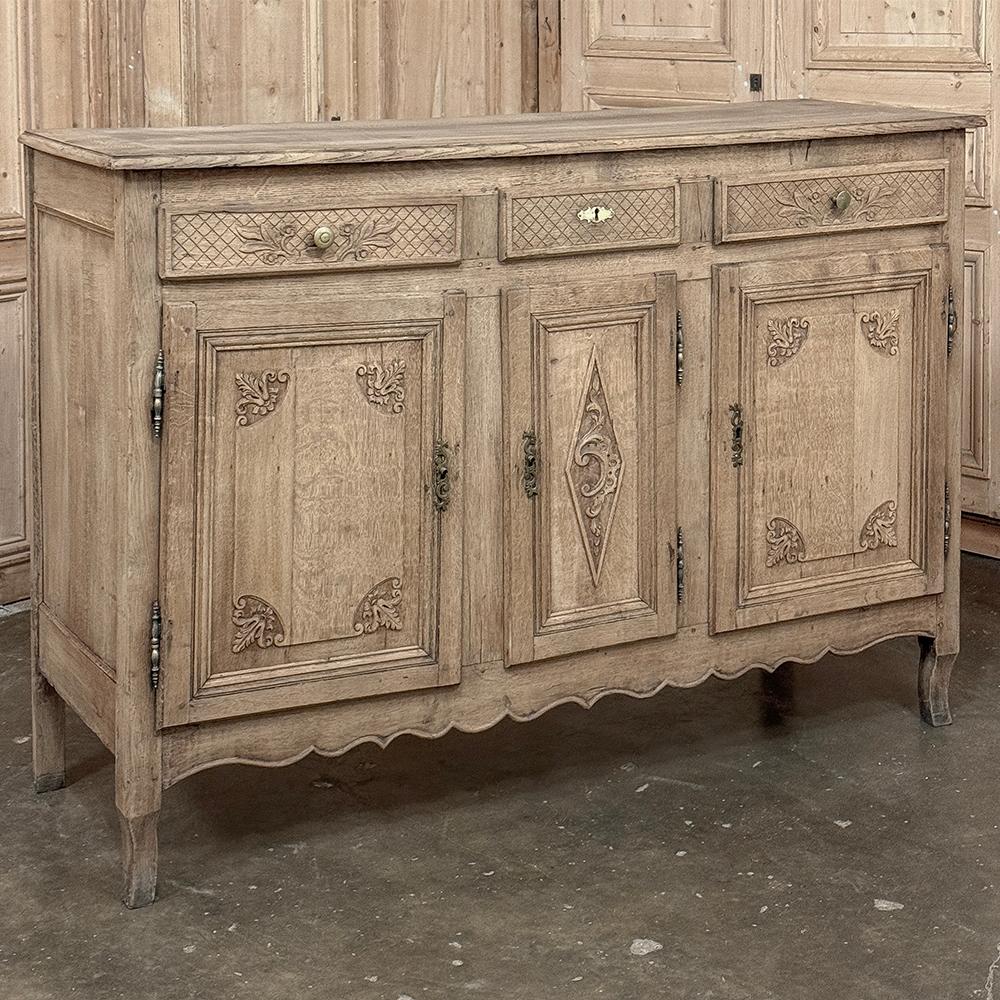 18th Century Country French Regence Buffet in Stripped Oak was crafted during the reign of Louis XVI who championed the neoclassical revival, but the country was in such a state of turmoil rural artisans did not necessarily follow the trends set by