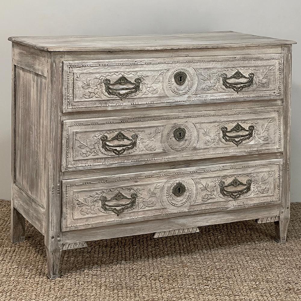18th Century Country French Whitewashed Commode was considered an essential furnishing in the 1700s as closets were virtually non-existent.  This example, rendered from solid oak with hand-carved and hand-crafted construction, was built to last for
