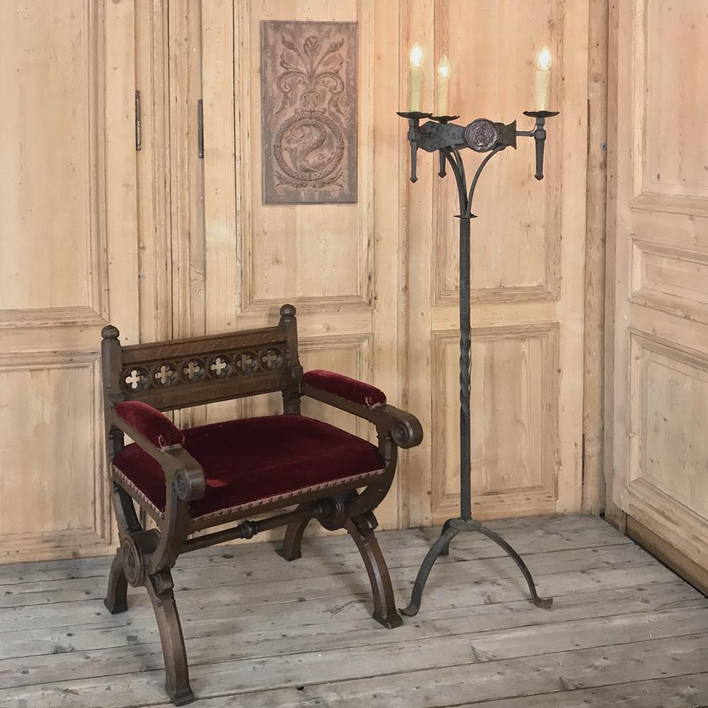 18th century Country French wrought iron torchere was originally designed for candles, and has now been cleverly electrified to make it the perfect choice for your masculine or casual decor! Hand-forged by a talented blacksmith, it features a tripod