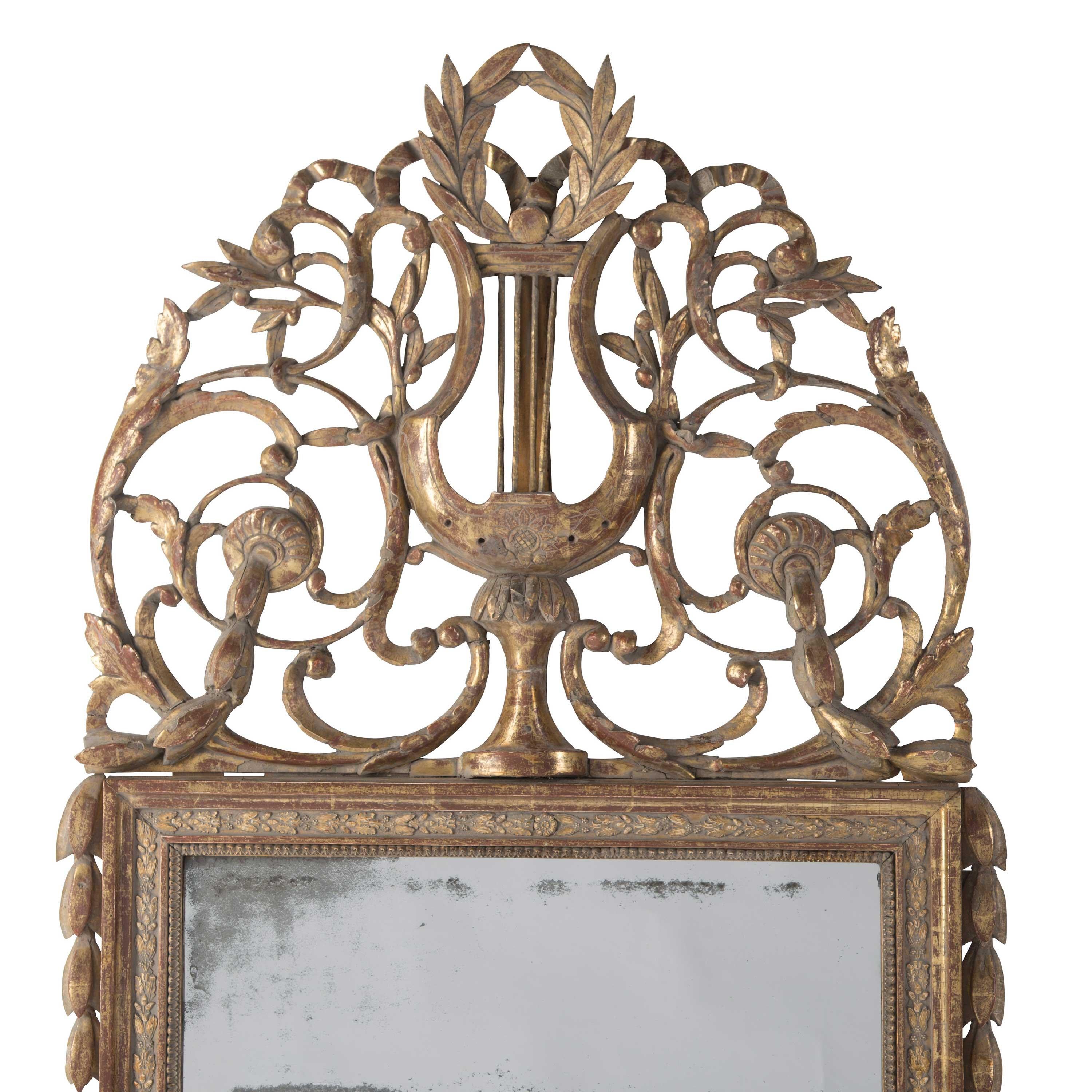 An exceptional mid-18th century French gilded and crested mirror in original condition.
