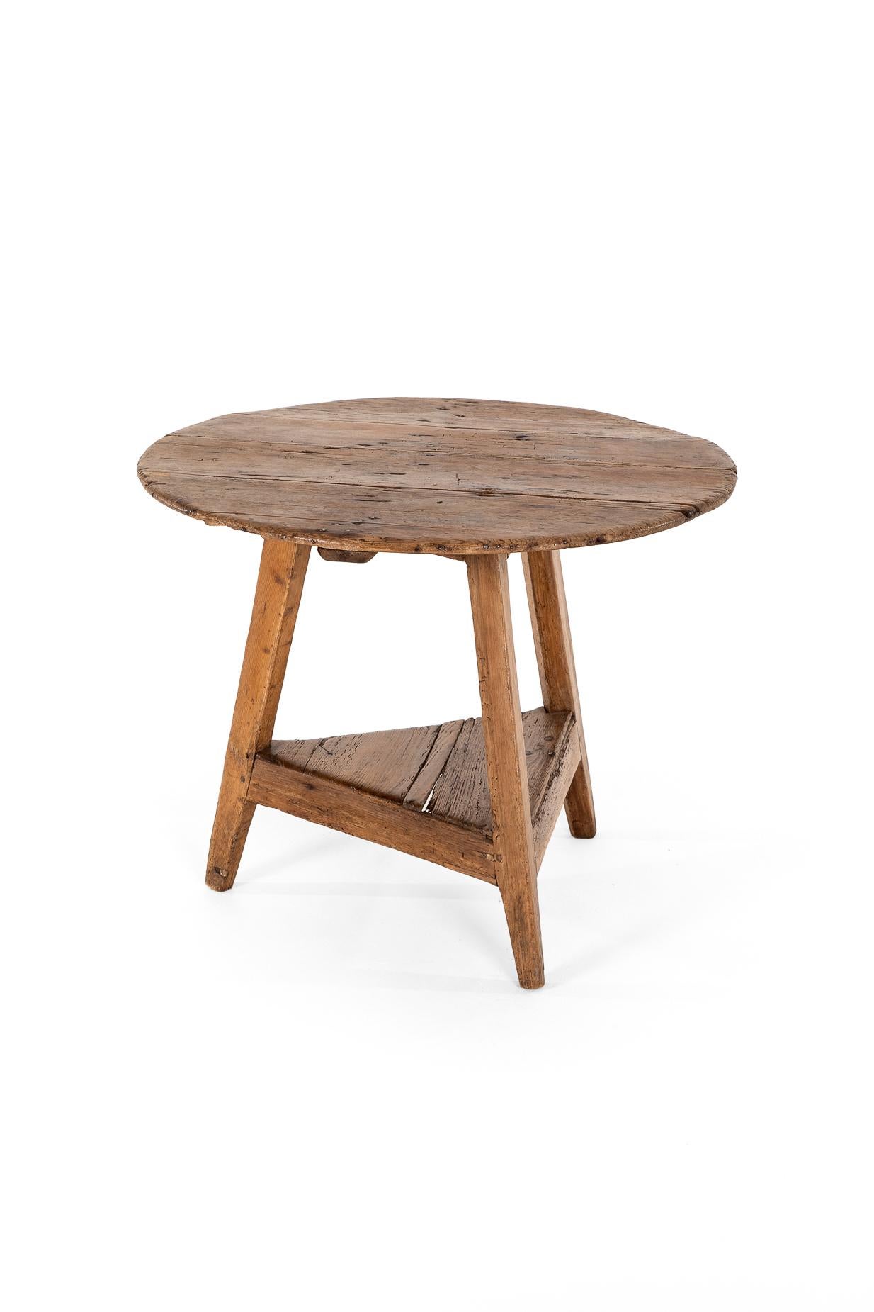 A primitive late 18th-century pine cricket table of great proportions, once used in a Welsh dairy.

From the beautifully weathered tabletop, we can assume that it once had an oil cloth attached to the surface, only adding to the delightful