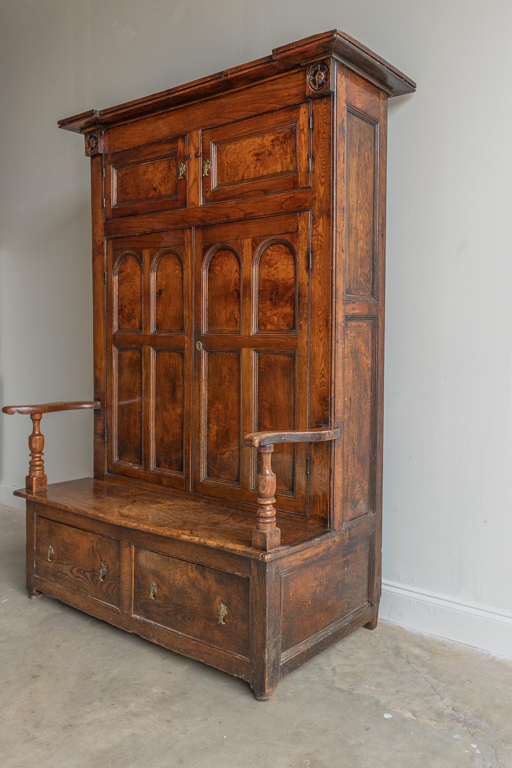 This beautiful and unique English cupboard is one of a kind. It has carved rosette corners, back fitted with four arch paneled doors. The base has two drawers and a pair of scroll arms. The original finish in excellent condition.