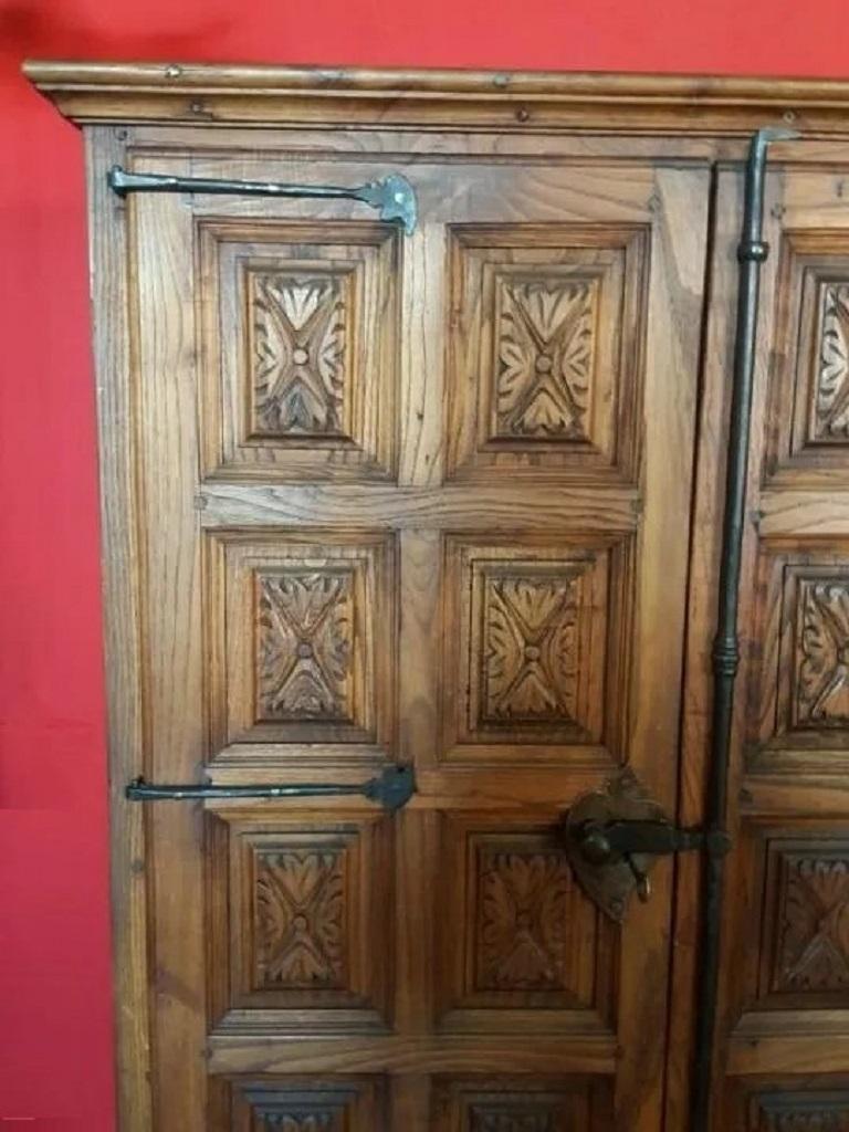 Grand 18th century Spanish armario or wardrobe armoire constructed from oak. Features a coffered case fronted by two large doors. This massive cabinet made in Spain features beautiful walnut grain and showcases the amazing craftsmanship. There is a
