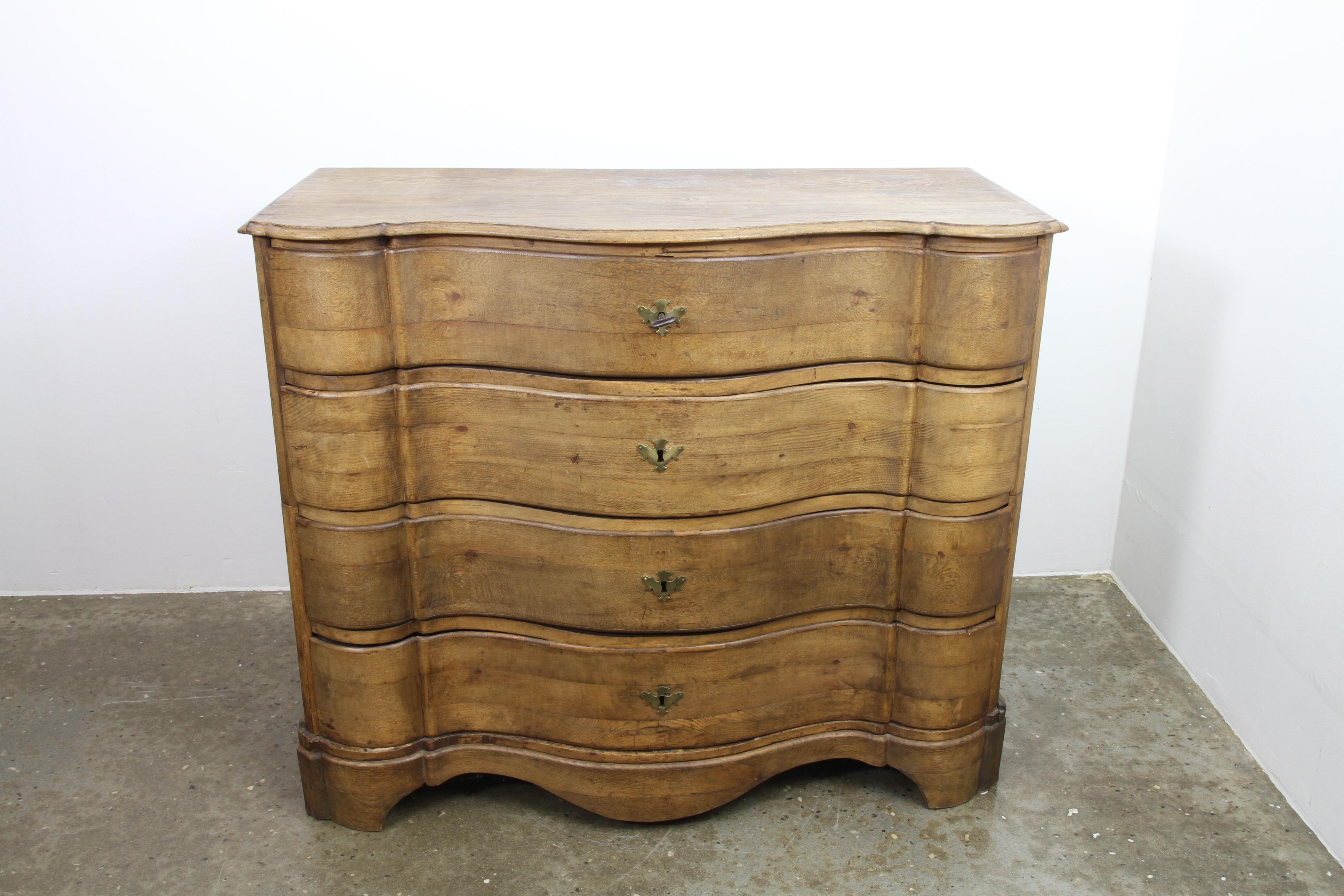 Immensely beautiful antique Danish chest of drawers. Very expressive look with amazing 260 year old patina. Four large drawers with curved fronts. Original key included. Incredible craftsmanship made this item last for generations. A unique