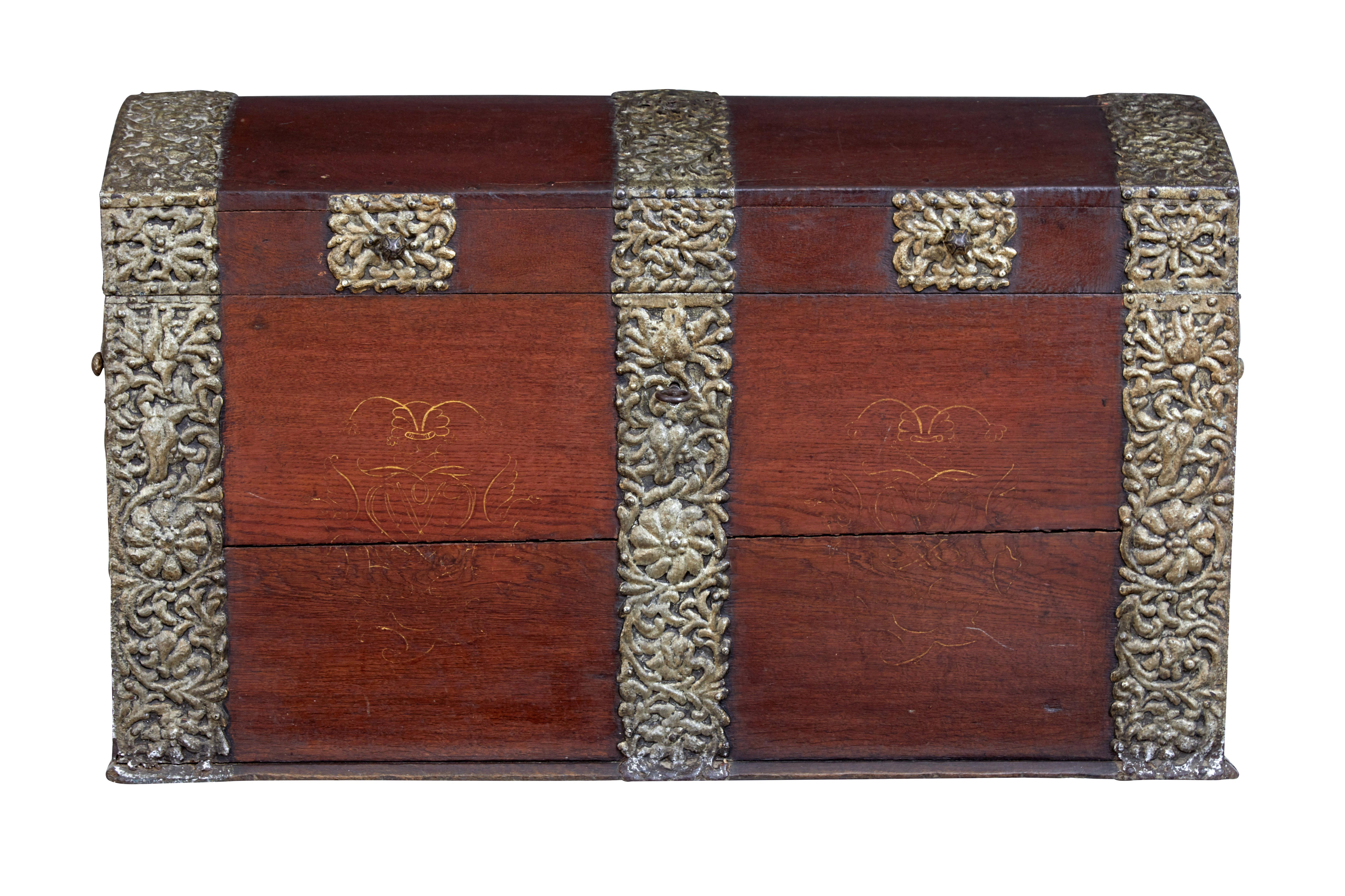 18th century danish oak dome top coffer circa 1790.

Beautiful dome top coffer made from solid oak, and decorated with ornate strap work.  Lid opens to reveal a partially fitted interior consisting on a candle box.

Strap work on both ends and over