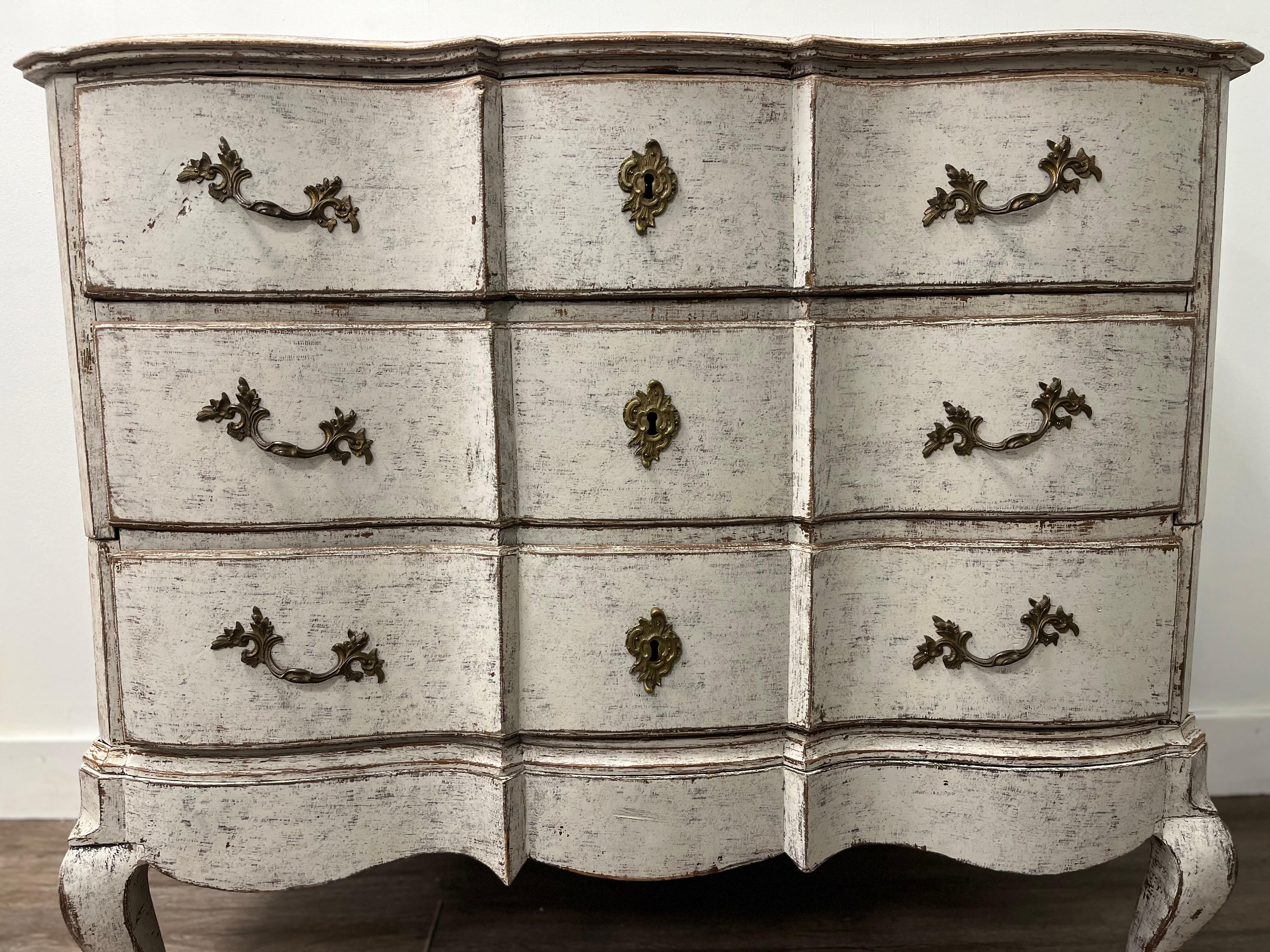 A unique 18th Century Danish Chest on Chest with serpentine drawer fronts and cabriolet legs. Upper chest has two large drawers and lower chest has one. Older brass hardware and iron locks. Tastefully repainted in light grey.
