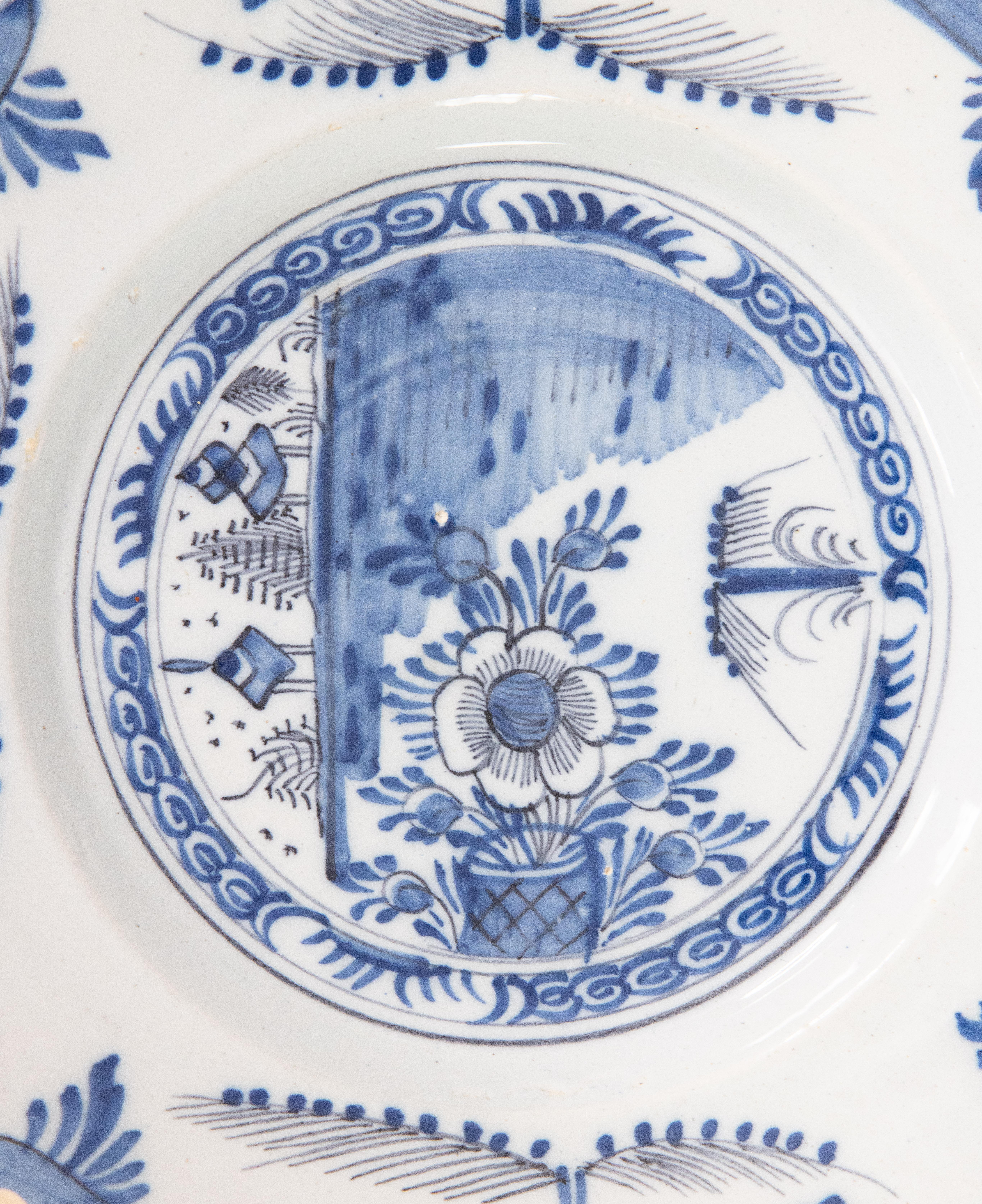 A superb antique 18th Century Dutch Delft Chinoiserie faience flower pot plate. This lovely plate has a hand painted flower pot and foliate border in cobalt blue and white. It would be wonderful displayed on a wall or in a