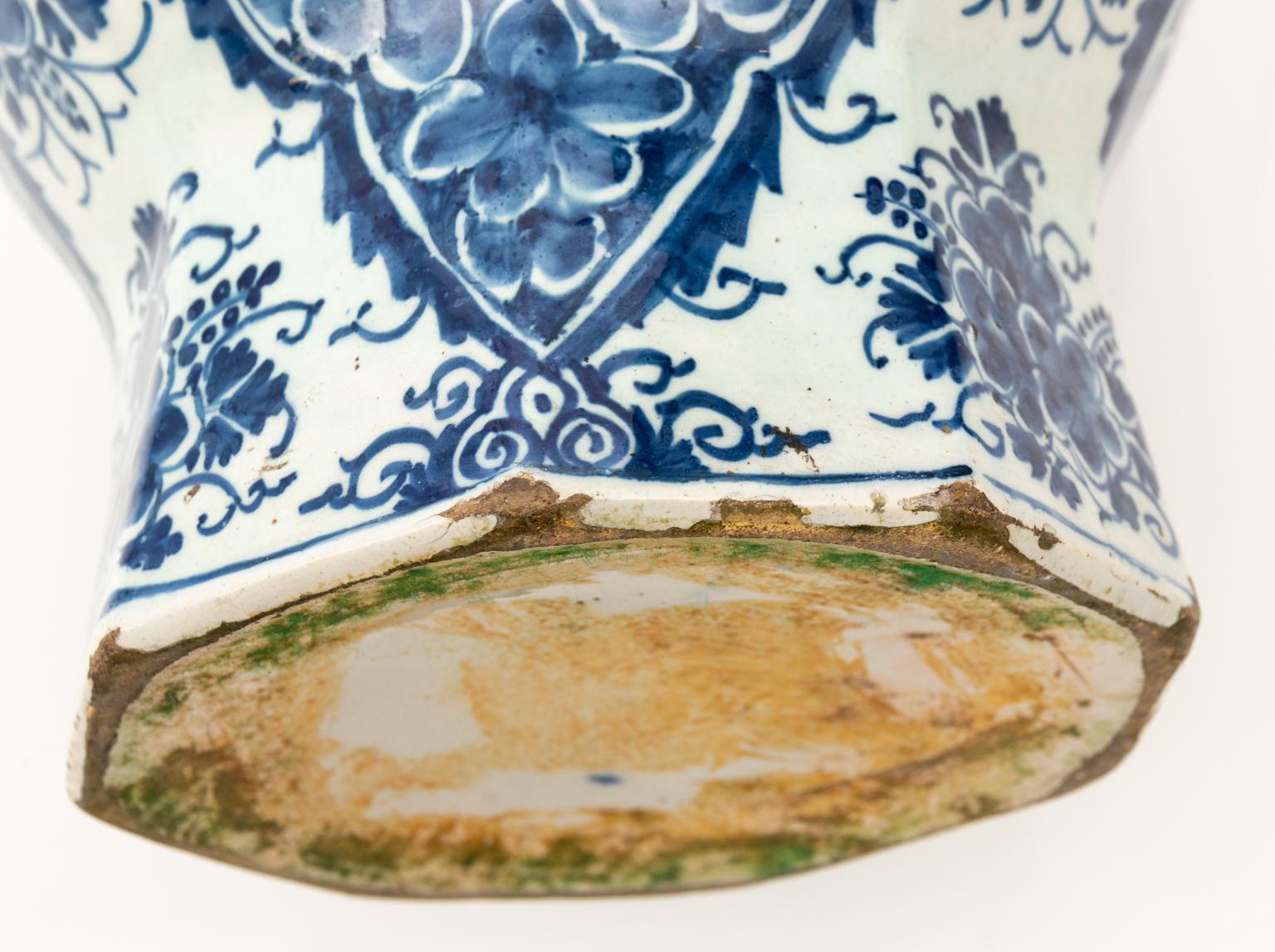 Blue and white Delft painted vase featuring floral detail throughout, circa 18th century. Please note of the small repair to the lip.
 