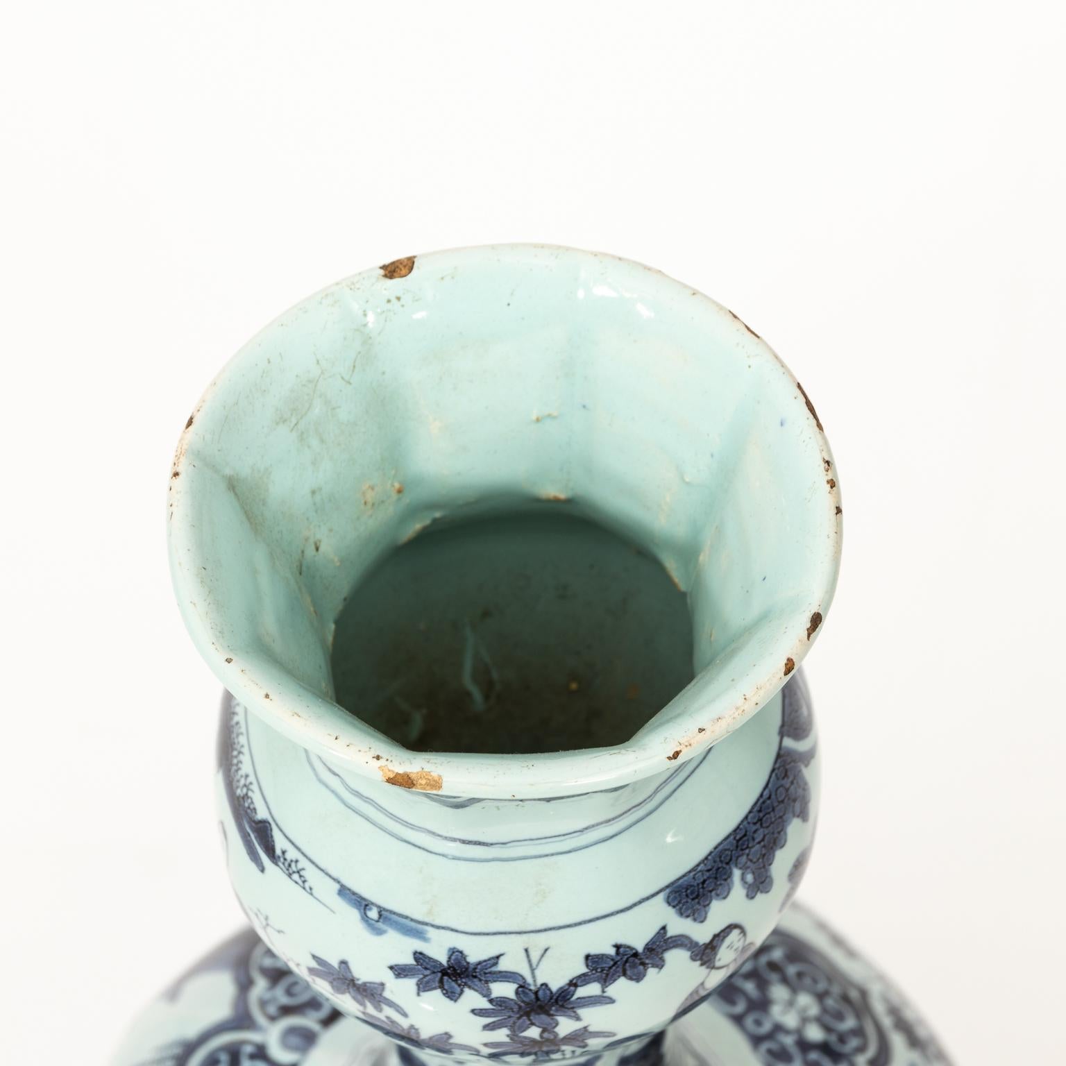 Blue and white painted delft vase featuring a Chinoiserie landscape scene, circa 18th century.
 