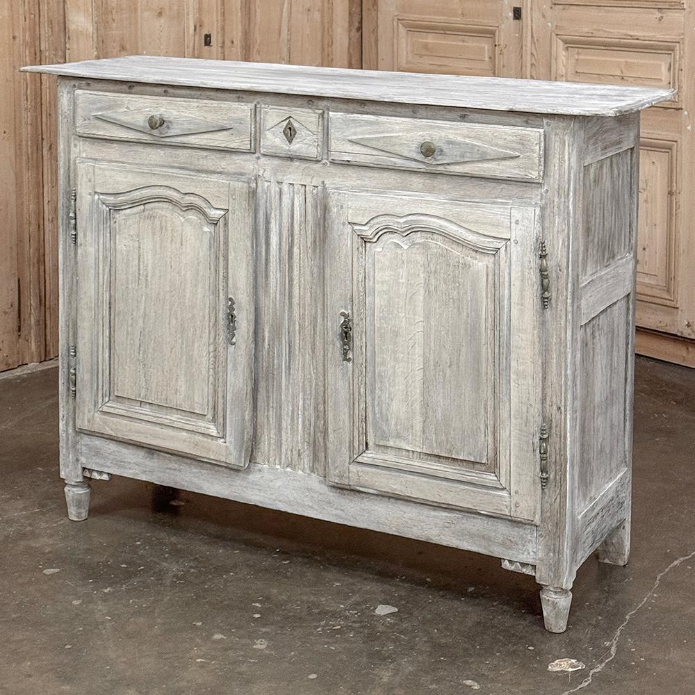 18th Century Directoire Period Country French Whitewashed Buffet is a splendid example of the tailored architecture made popular just before and after the turn of the 19th century.  Hand-crafted from seasoned old-growth oak, it features a generous
