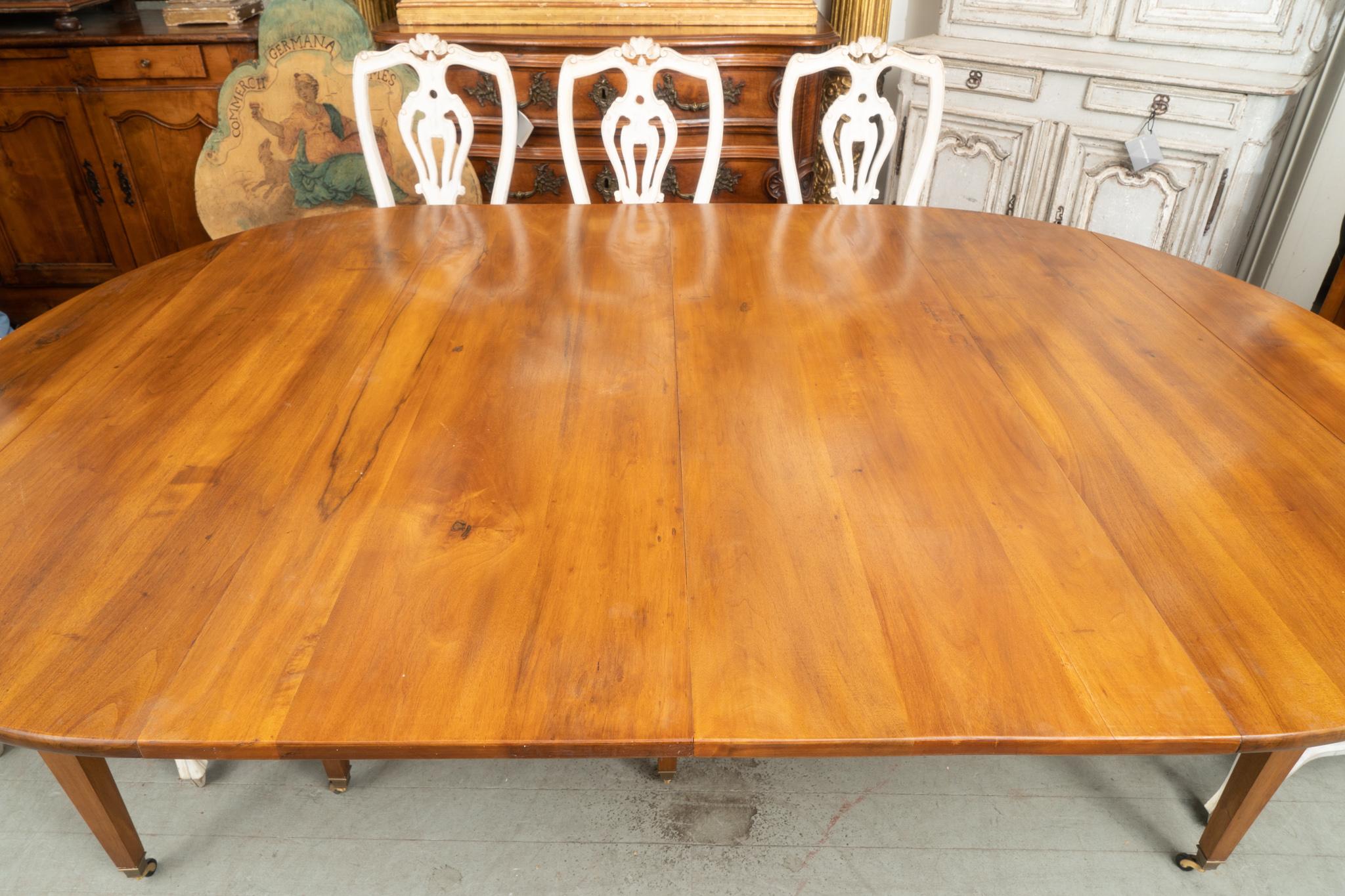 Beautiful period directoire walnut extension table shown with two leaves. There are three extra finished leaves each adding 19.5” to the total length.