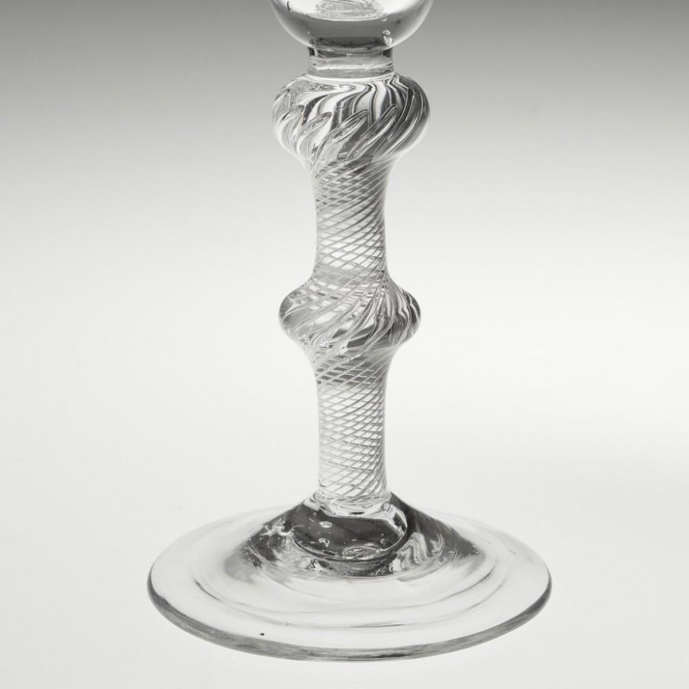 Heading : A double knop multi spiral air twist stem winer glass
Period : George II- Geotge III c1750
Origin : England
Colour : Clear, good blue-grey tone
Bowl : Bell shaped
Stem : A short plain stem section abobve an inverted baluster knop and