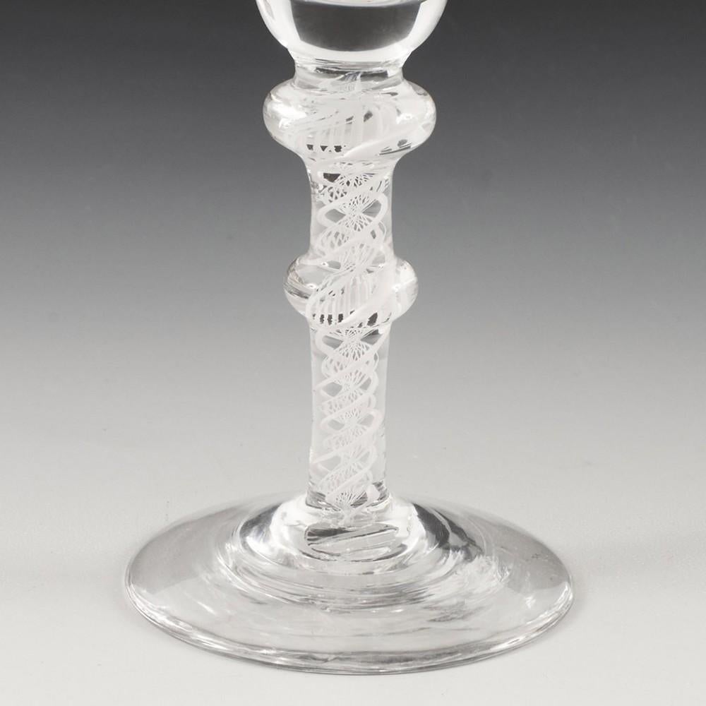 Heading : 18th Century Double Knop Opaque Twist Wine Glass
Period : George III
Origin : England
Colour : Clear
Bowl : Bell shaped
Stem : A pair of spiral threads outside a lace corkscrew
Foot : Conical
Pontil : Snapped
Glass Type : Lead
Size : 