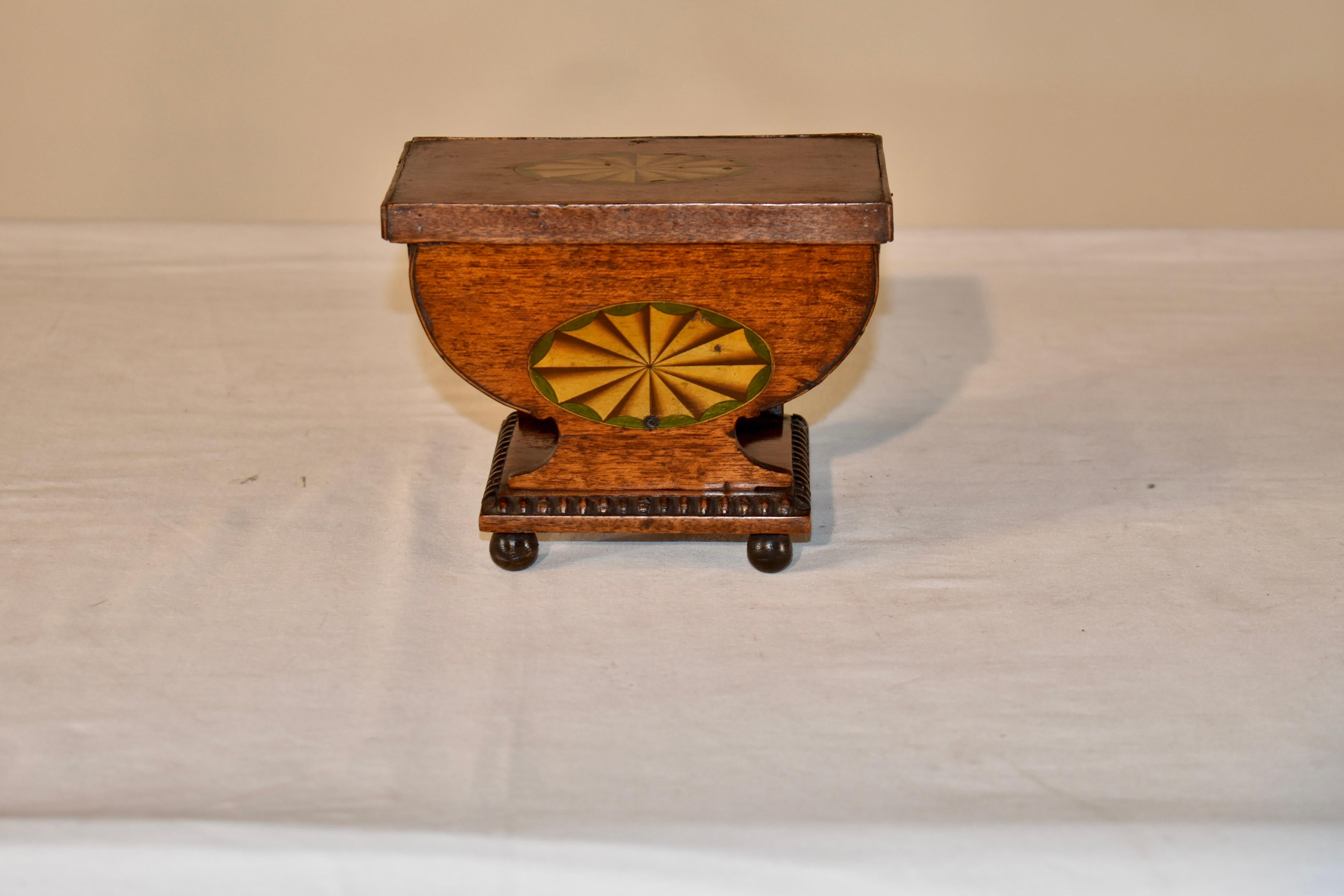 Late 18th century dresser box with lid made from oak.  The lid is banded , and tops the curved box.  The box has a lovely shape to it and is constructed in such a way that the bottom of the box is curved into an urn shape, and is resting on a lovely