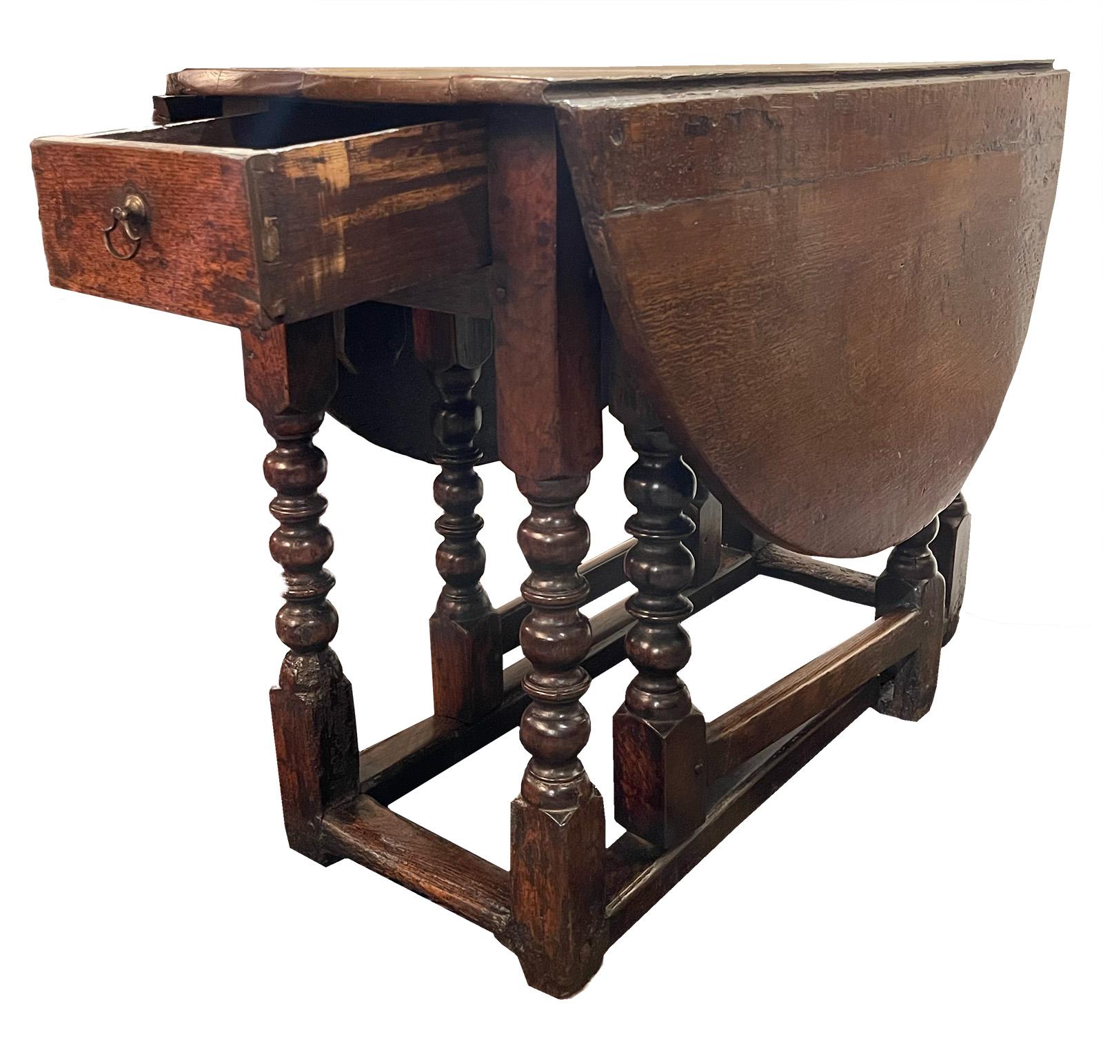 An 18th century English drop-leaf table made from walnut.

Dimensions: 49