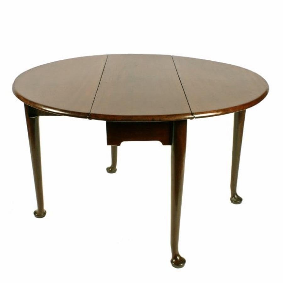 An 18th century Georgian mahogany drop leaf pad foot table.

The table stands on four turned legs with pad shaped feet, one leg on each side gates open to support a leaf.

With both leaves up it forms a dining table large enough to sit six