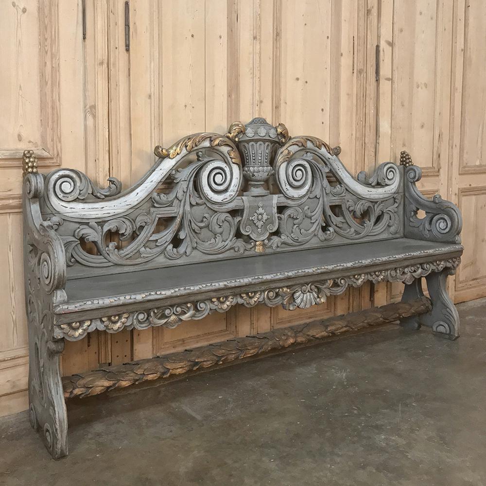 18th century Dutch Baroque painted hall bench is a work of the wood sculptor's art! Highlighted in paint with gold finishing touches, it features motifs from an urn centered on the seatback crown to elaborate acanthus plumes pierce-carved for a