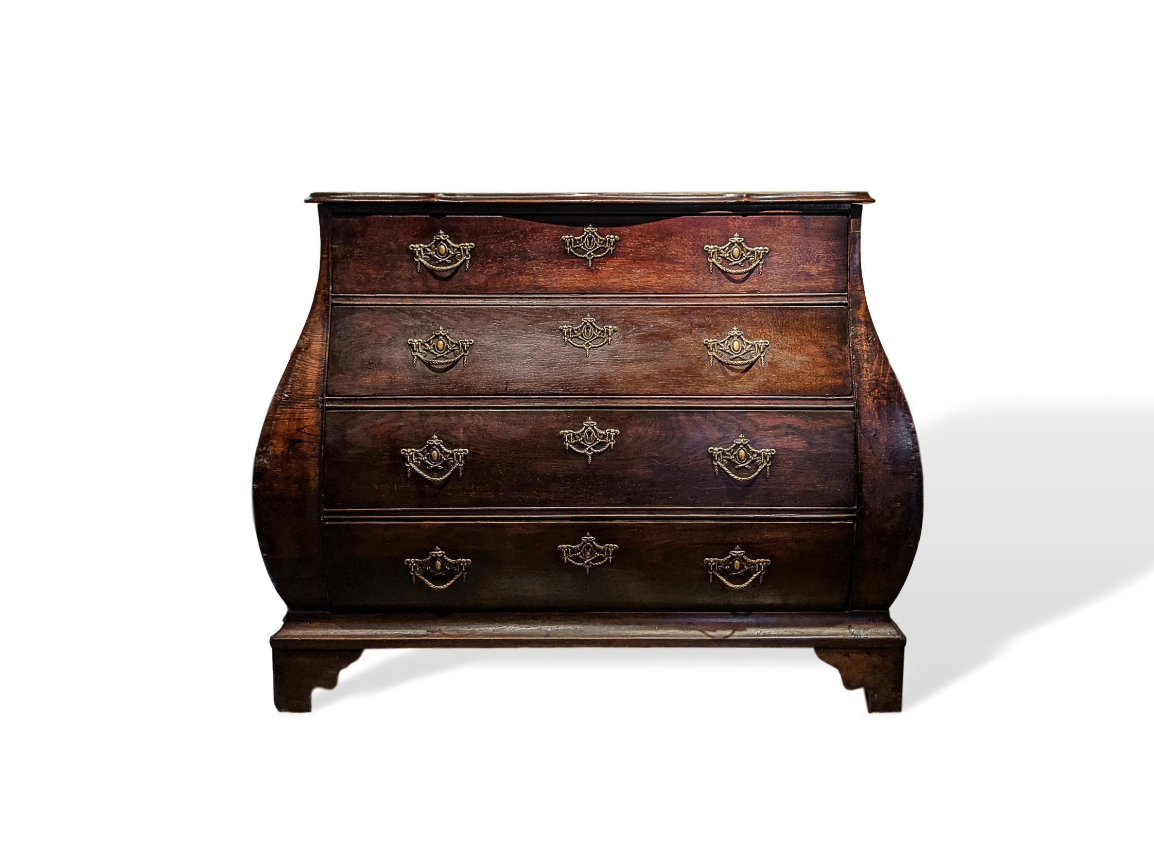 18th century Dutch Baroque oak Bombé commode/chest, elaborate, original hardware, the shaped and molded top, over four graduated drawers, on a molded plinth with shaped bracket feet; the finely cast, intricate solid brass hardware is original to the