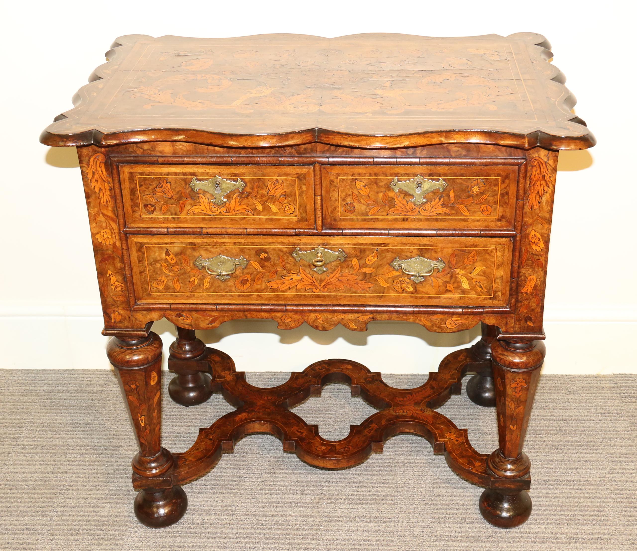 A mid-18th century Dutch burr walnut and marquetry lowboy. It has thick hand cut veneers with typical designs of birds, foliage and flowers and has original handles and locks to the three drawers. A rare feature of this lowboy is that it doubles as