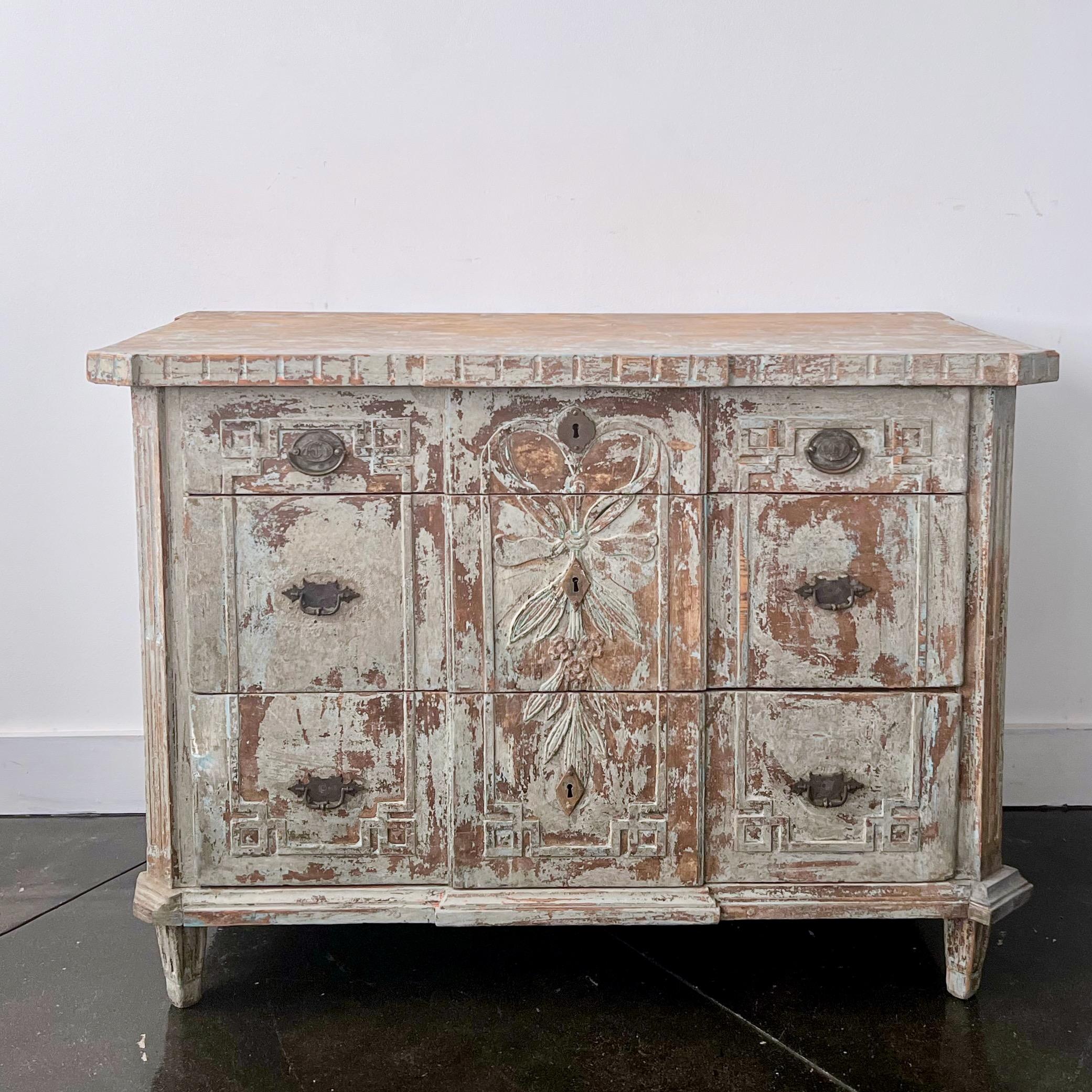 18th century ca 1780 three drawers Dutch chest in richly carved drawer fronts, original intricately detailed hardware and escutcheons, shaped top, handsome original large iron handles on the side panels - Charmingly with remnants of white paint that