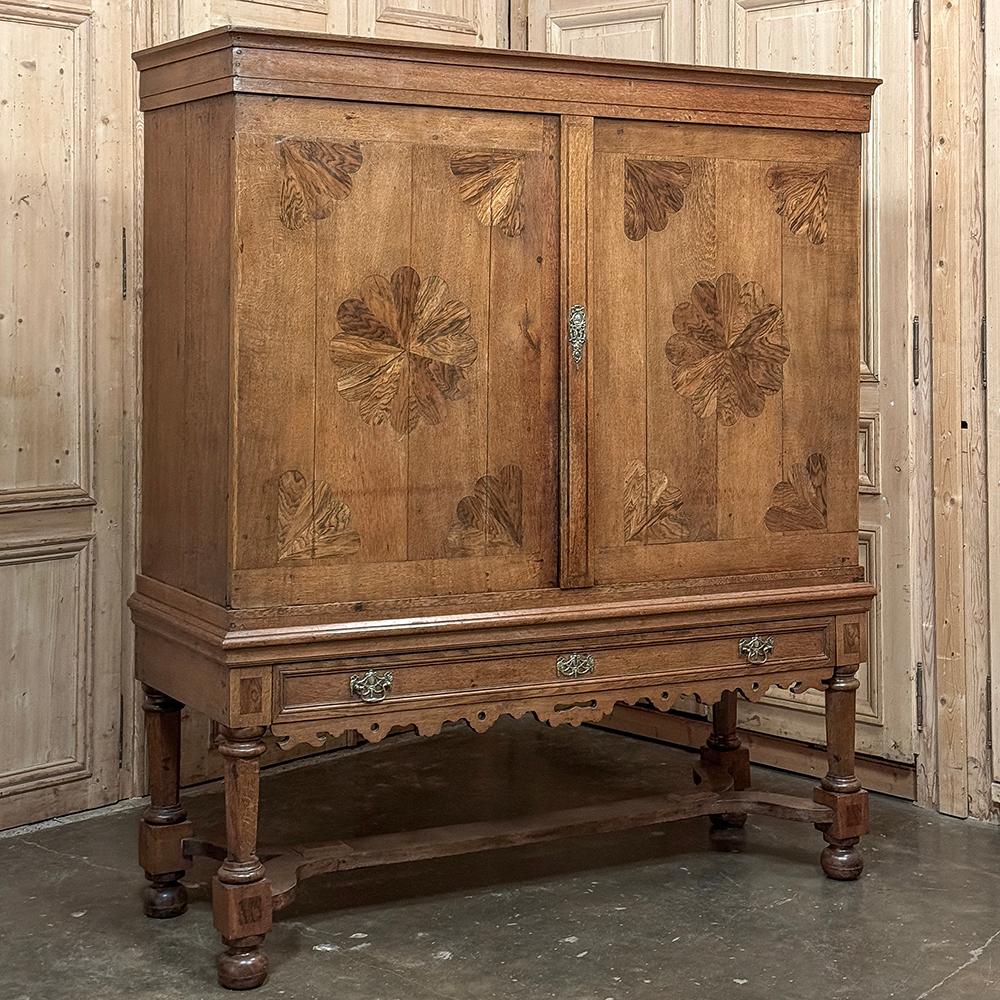 18th Century Dutch Cupboard with Inlay was crafted by incredibly talented artisans to create the complete serving and storage cabinet for an affluent family.  The exterior consists of hand-selected oak, with a subtle yet prominent crown overlooking