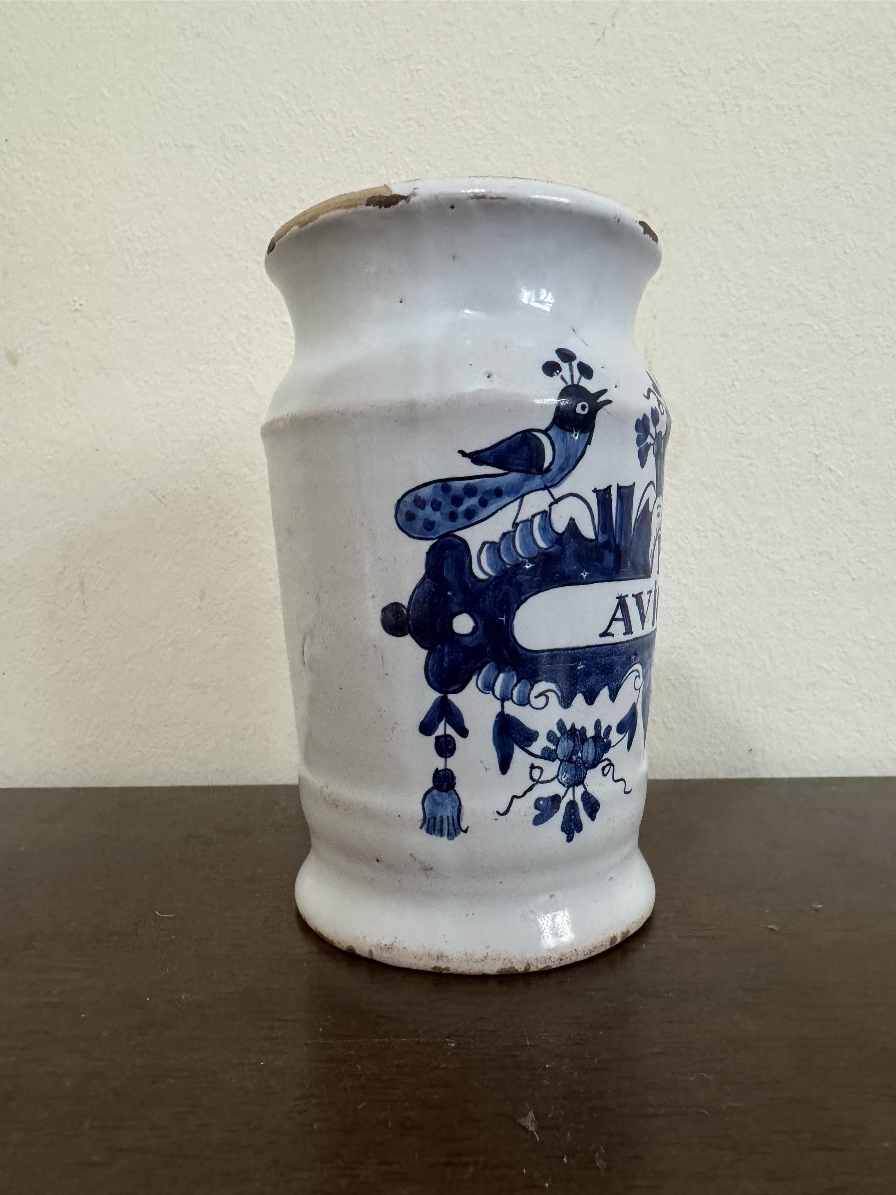 A good Dutch Delft blue and white pottery apothecary jar marked P.AVICEMA and dating from around 1750. The jar, of cylindrical form stands on a rounded pedestal foot with a pinched top rim and slightly flared top. The jar is hand decorated with a