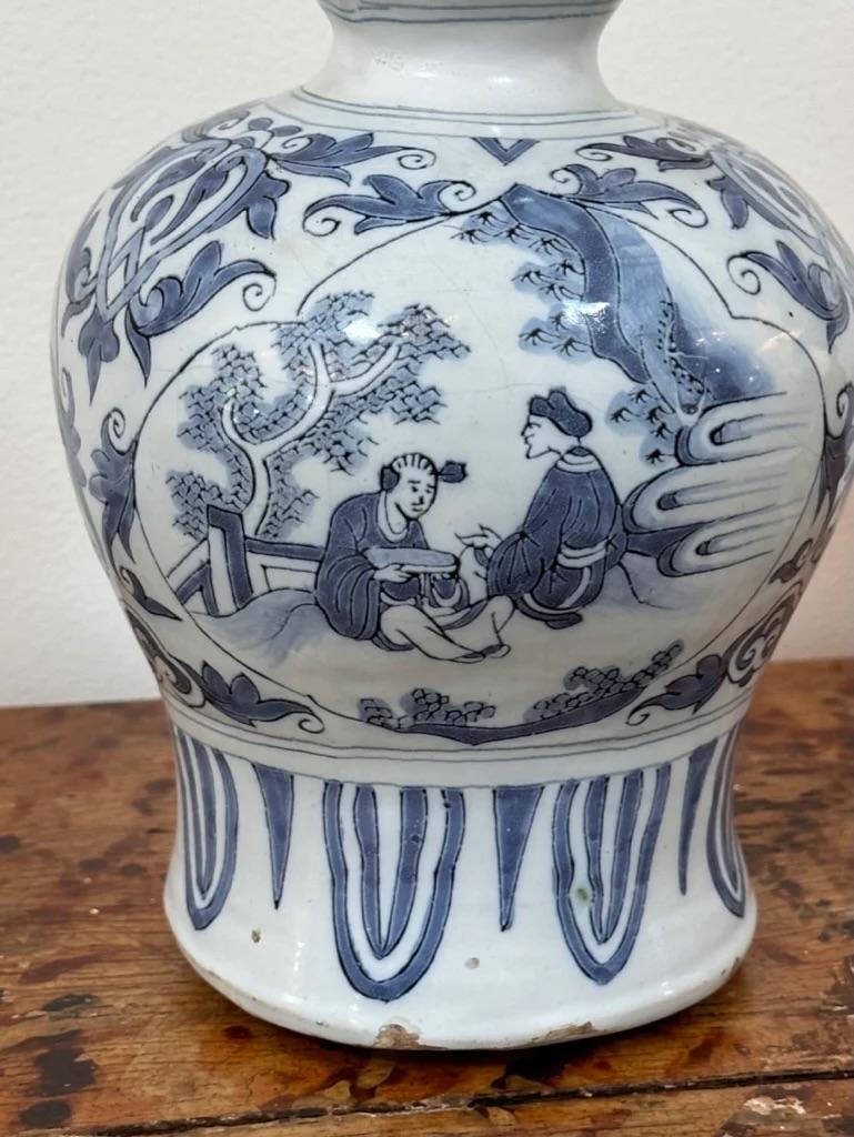 Dutch Delft Blue and White Vase, 18thc. Garlic head form decorated with chinoiseries in cartouches with floral scroll and lappets.  13.5” h. x 7” diam. 
