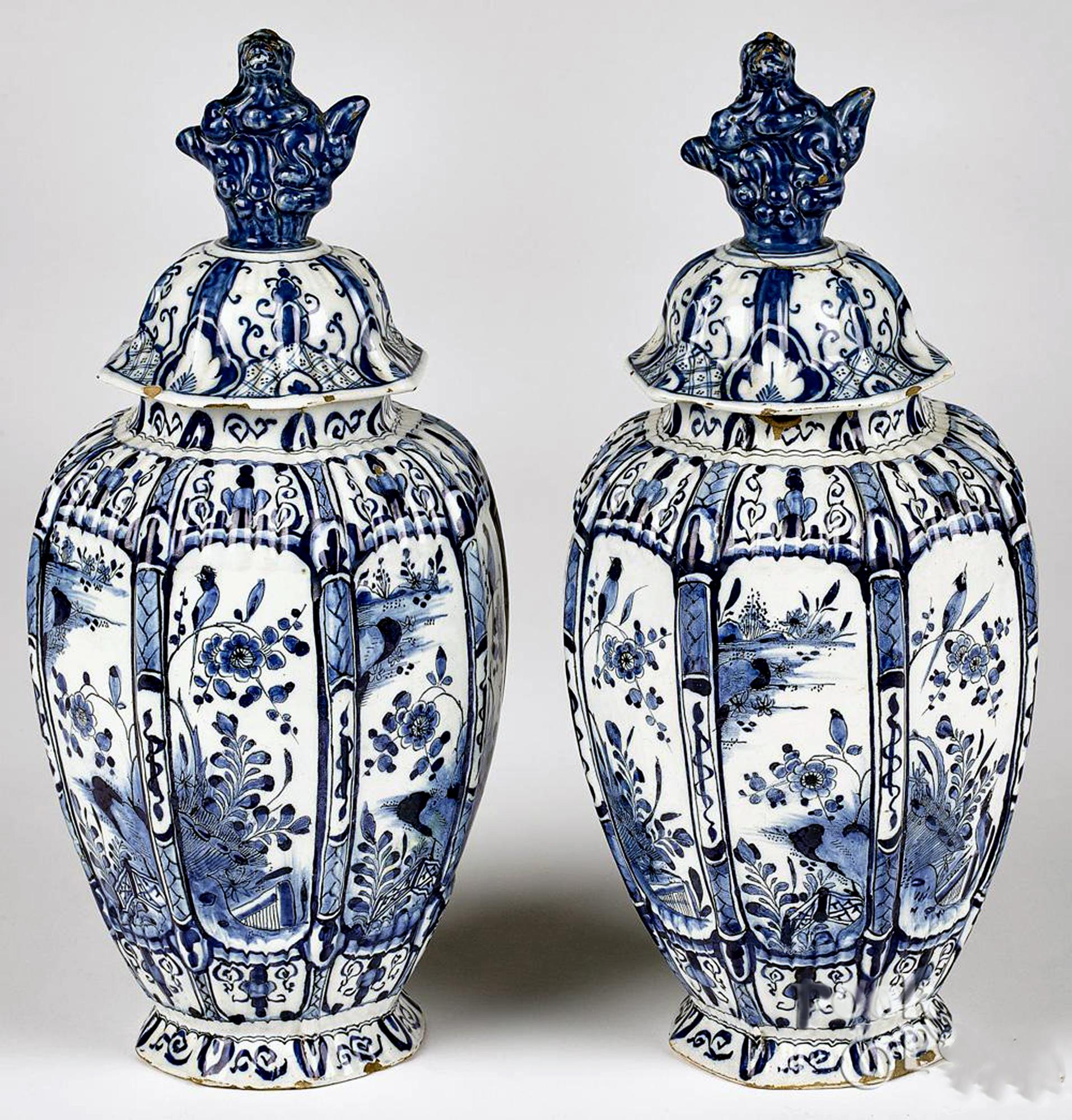 Dutch Delft Underglaze Blue & White Vases & Covers,
De Twee Scheepjes Factory ( The Two Little Ships),
Mid 18th Century

The pair of Dutch Delft octagonal shaped vases and cover are painted in underglaze blue & white with garden scenes in underglaze