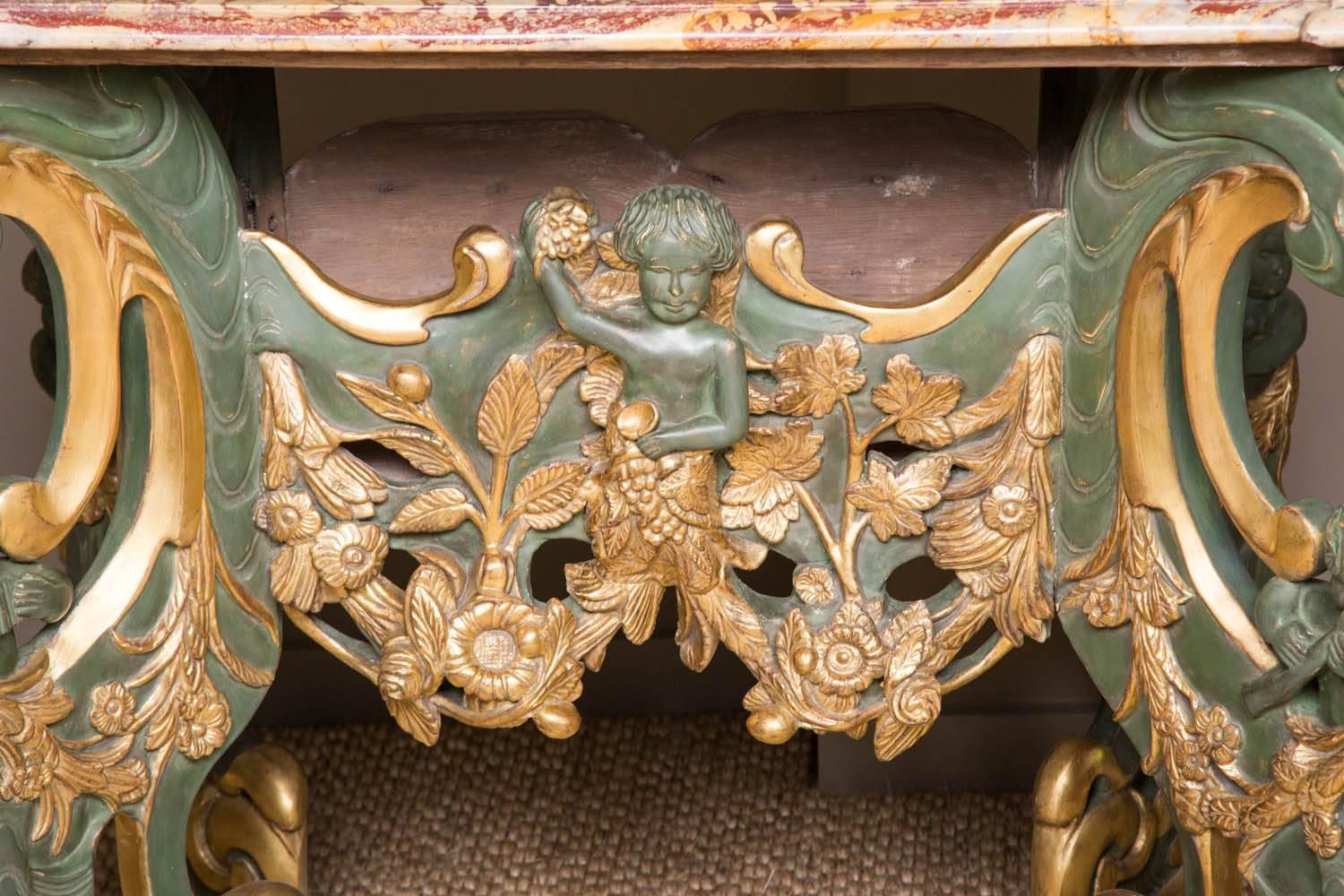 A charming Dutch late 17th century 'Kwab' or centre table. Decorated in a green painted surface with gilded highlights. Typical Baroque scrolling legs and decoration. The marble-top later and associated. The table dates from circa 1700.