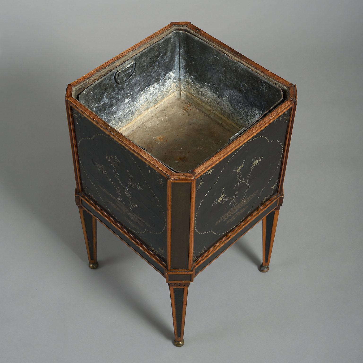 The square form with canted corners, mounted with oriental lacquer panels, probably from a tea-box, and raised on angled square tapering legs, also inset with lacquer panels and standing on brass ball feet.