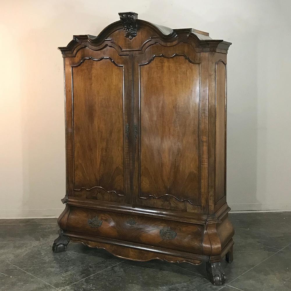 18th century Dutch mahogany armoire - Cabinet is an unusual example of the genre, which were normally produced from indigenous woods. This stunning example, with triple crown centered with a corbel platform designed to hold a small statue of a