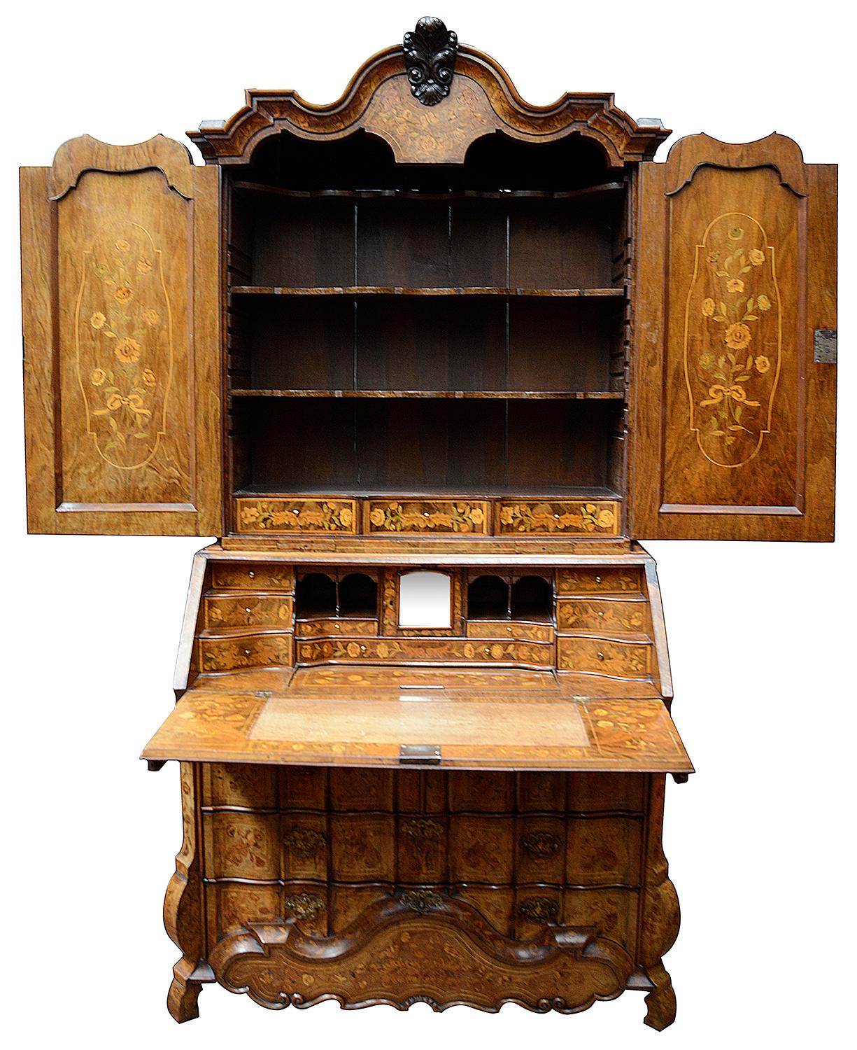 A very imposing good quality 18th century Dutch Marquetry bureau bookcase, having wonderful flowers, birds, classical scull and urn decoration. The two doors above opening to reveal inlay to the reverse, three adjustable shelves and three inlaid